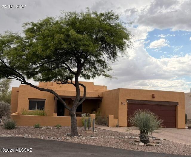 Beautiful Santa Fe style home in Oro Valley, Naranja Ranch. Over 1/2 acre on quiet dead-end street. Rusted metal garage door, paver driveway and gated front courtyard. Large back patio with firepit area and 100 gallon rain tank. Updated interior has 42'' maple cabinets and drawers, all soft close. Quartz countertops are durable and lovely. Baths were updated with new vanities, lights, toilets, tiled showers and sliding glass doors. 6 skylights, saltillo tile and a kiva fireplace keep the SW feel inside. Knotty alder barn door separates main bedroom from bath. Large laundry room has plenty of storage and room for a desk. Close to Oro Valley's amenities; bike/walking paths, community center, library, parks, restaurants and shopping. Listing agent is seller.