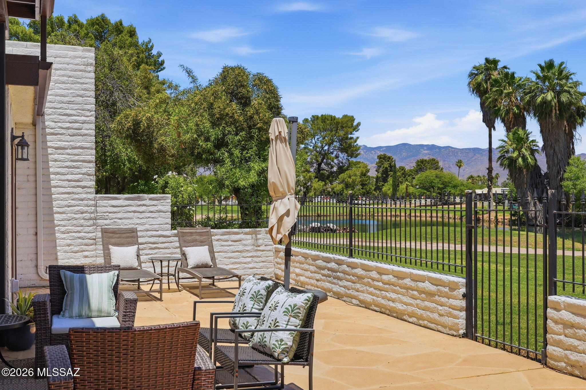 Tastefully updated Dorado Country Club Estates Townhome on a premium view lot overlooking the pond, golf course, and Catalina Mountains. Floor-to-ceiling windows provide abundant natural light. Flexible floorplan with 3 bedrooms and 3 full baths, including first-floor primary suite and guest bedroom for convenient single-level living. Upstairs guest suite features private balcony. Updated Kitchen with Maple Cabinets with pullouts and Granite Counters. Travertine tile flooring, recessed lighting, ceiling fans, six-panel doors, and generous storage throughout. Enjoy private oasis community pool, spa, gazebos, pond and stream. Nearby guest parking.