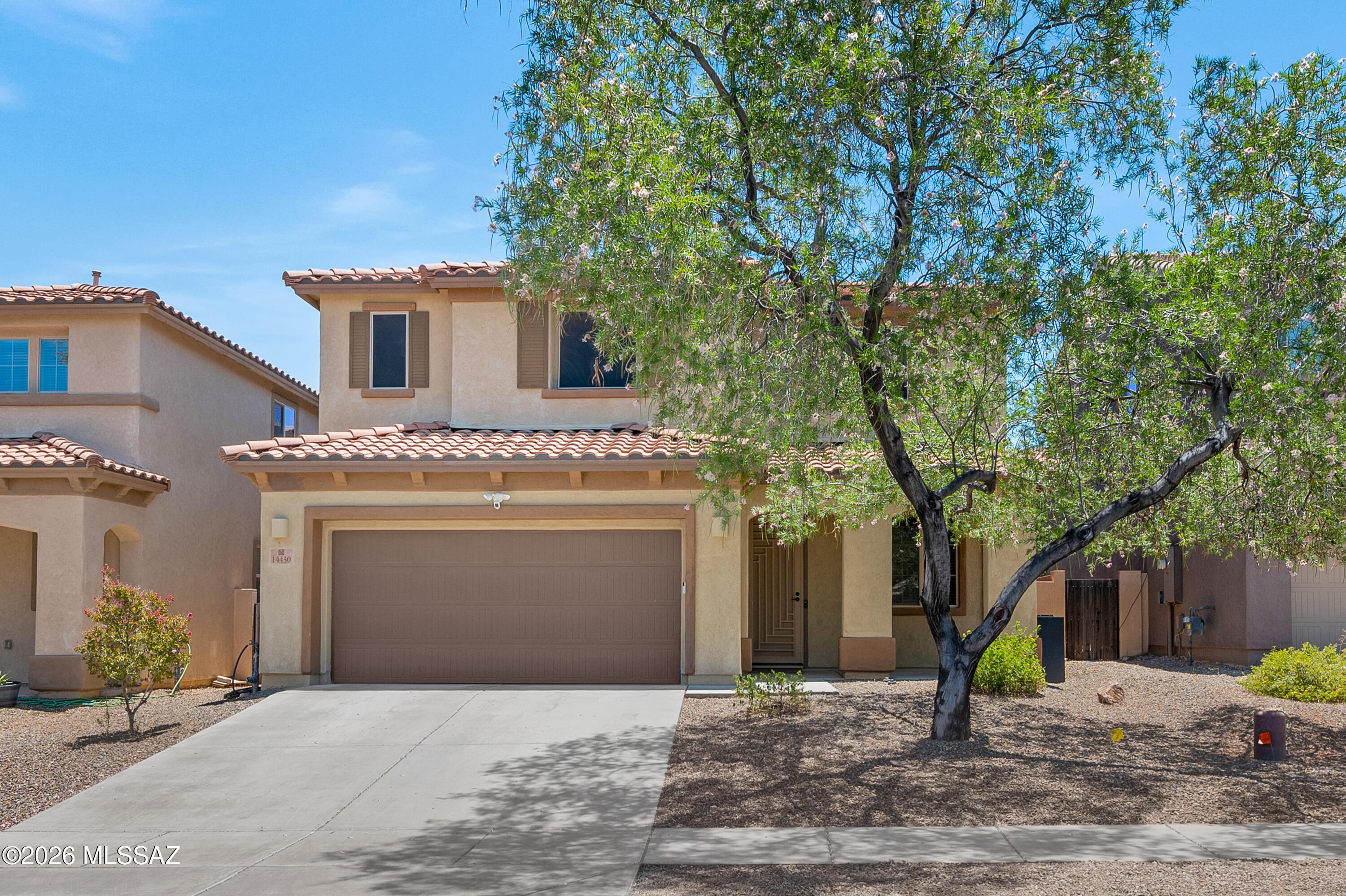 Beautiful 4-bedroom, 2.5-bath home with  den in Rancho Sahuarita! This home features a spacious floor plan with living and family rooms, no carpet, and low-maintenance front and back yards. The downstairs includes a versatile den, powder room, and open kitchen with a walk-in pantry, reverse osmosis system, and Water-Tec water softener. Upstairs features four bedrooms with walk-in closets, dual sink bathrooms, and a convenient laundry room. Energy-efficient upgrades include leased solar, sun screens, and a Tesla charging station in the 2-car garage. Close to parks, schools, shopping, and freeway.