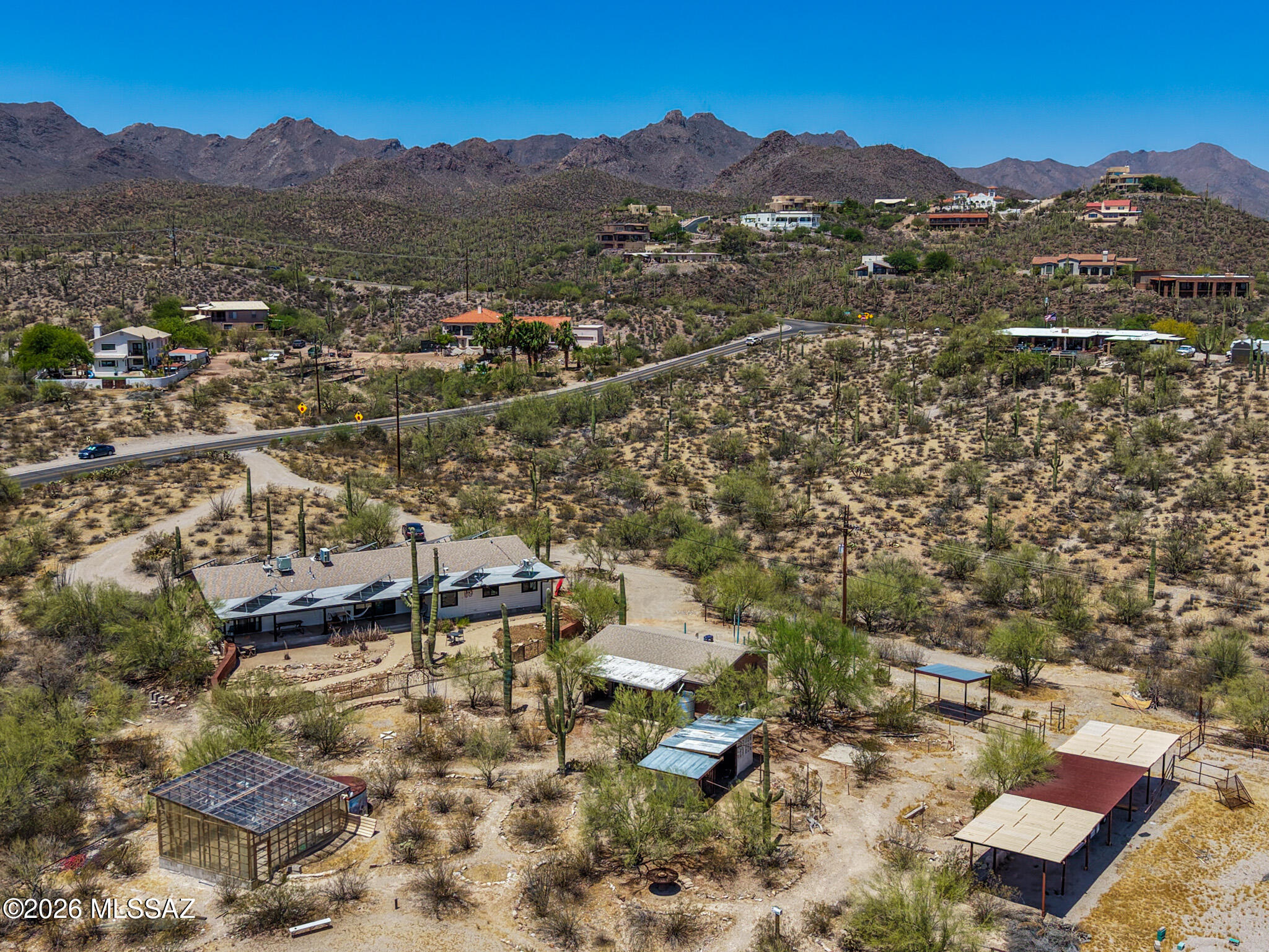 Welcome to your private desert retreat on 3.21 acres with breathtaking mountain and city-light views, conveniently located near Gates Pass, fully paid-off solar, and no HOA. This exceptional property offers the perfect combination of sustainable living, privacy, and modern comfort. The beautifully remodeled 2,292 sq. ft. main residence features 4 bedrooms, 3 full bathrooms, and two private en-suites, each with its own entrance, making them ideal for guests, multigenerational living, or a home office. The open-concept floor plan creates an inviting space for entertaining and everyday living, while the kitchen is equipped with appliances that are less than a year old. Three newly remodeled designer bathrooms add a fresh, modern touch throughout the home. A standout feature of this property is the 100% owned and paid-off solar system. The solar system powers both the main home and the 768 sq. ft. guest house, resulting in little to no electric bill. The current owners report that the system consistently produces more energy than the property consumes, often generating a credit from the utility company. With no gas bill and virtually no energy costs, this carbon-neutral property offers incredible long-term savings and efficiency. The detached guest house includes 1 bedroom, 1 bathroom, a full kitchen, and a washer and dryer hookup, providing excellent flexibility for guests, extended family, rental income potential, or a private workspace. Outside, you'll discover a true desert oasis. The property includes horse fencing and a chicken coop, a greenhouse with electricity, and numerous walking paths throughout the acreage. Relax around the fire pit, gather with friends in the outdoor seating area, or enjoy the newly installed designer backyard gate that enhances both beauty and functionality. Watch spectacular sunsets as the mountains change colors and the city lights begin to twinkle below.Enjoy the hiking and biking trails, this one-of-a-kind property offers the serenity of country living while remaining close to Tucson amenities. Experience sustainable luxury, unmatched views, and endless possibilities in this extraordinary desert estate.

Please see the Documents tab for a complete list of upgrades and improvements.
