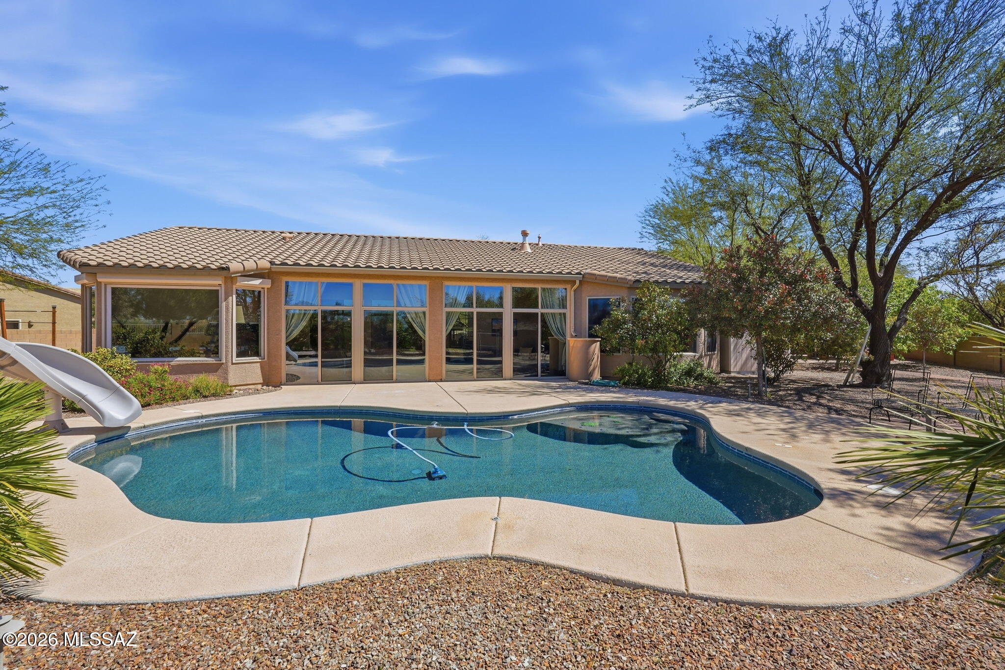 Welcome home to this move-in ready 5-bedroom, 3-bath home in Rincon Trails! Situated on .51 of an acre with no rear neighbors, this property offers space, privacy, and room to enjoy the outdoors. Step into the backyard oasis featuring a sparkling pool, a seating and barbecue area perfect for entertaining, and an enclosed patio that provides additional outdoor living space. With plenty of room inside and out, this home is ideal for relaxing, hosting, and enjoying Arizona living. Come see everything this property has to offer!
