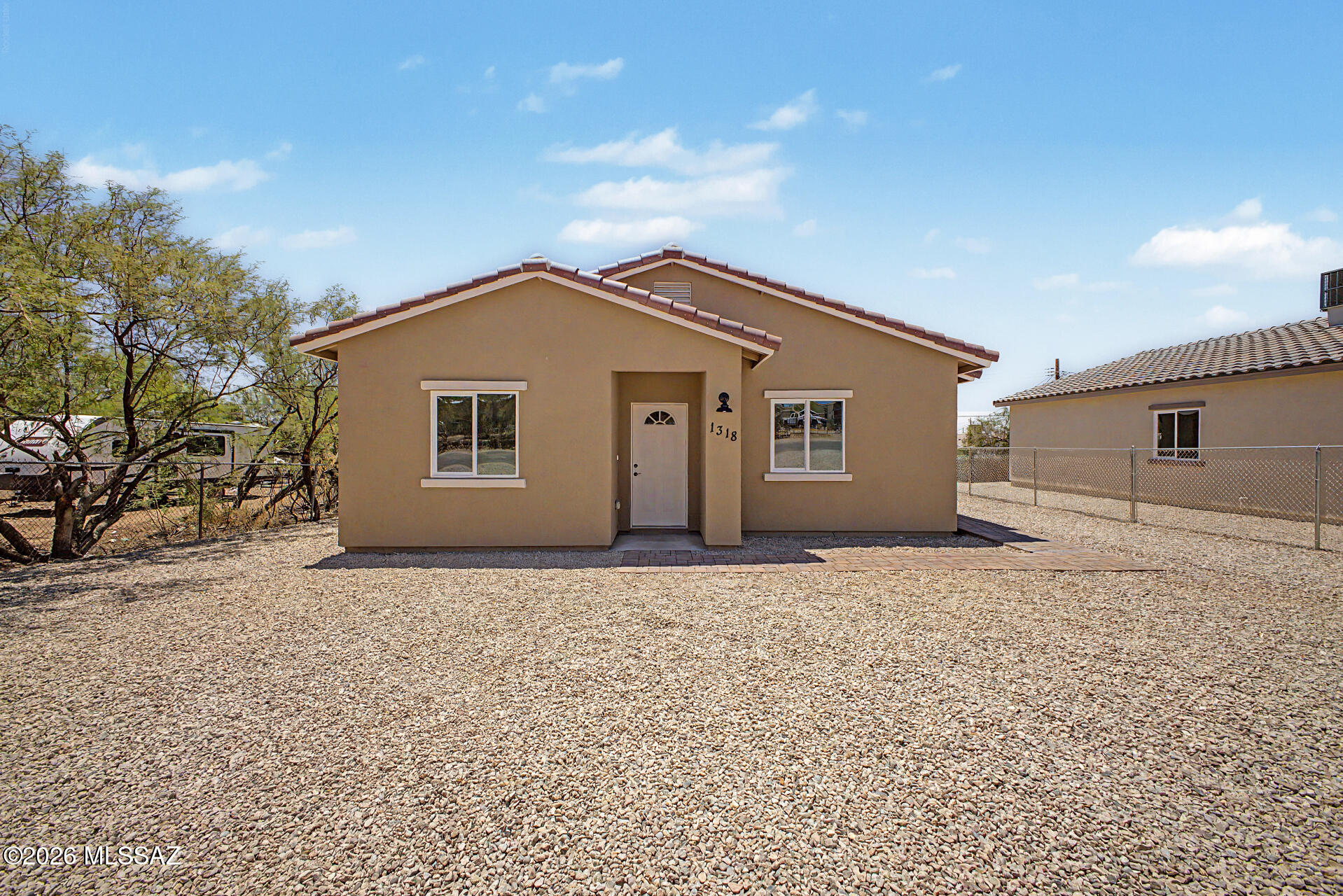 Look no further! This NEWLY BUILT single-level residence in Tucson is the one! Nestled on a  fenced lot, it provides 3 beds and 2 baths. The inviting interior boasts clean lines that promote a modern feel! Enhanced by a neutral palette, tons of natural light, ceiling fans in every room, and tile flooring throughout. You'll love the seamlessly flowing open layout, making entertaining a bliss! The kitchen boasts brand-new SS elec range & microwave, quartz counters, recessed lighting, and wood shaker cabinetry w/crown molding. The primary bedroom includes a walk-in closet and a private bathroom for added comfort. Bring your vision to life in the perfectly sized backyard, offering room for everything from outdoor gatherings to future additions. Welcome to a place where new memories begin!