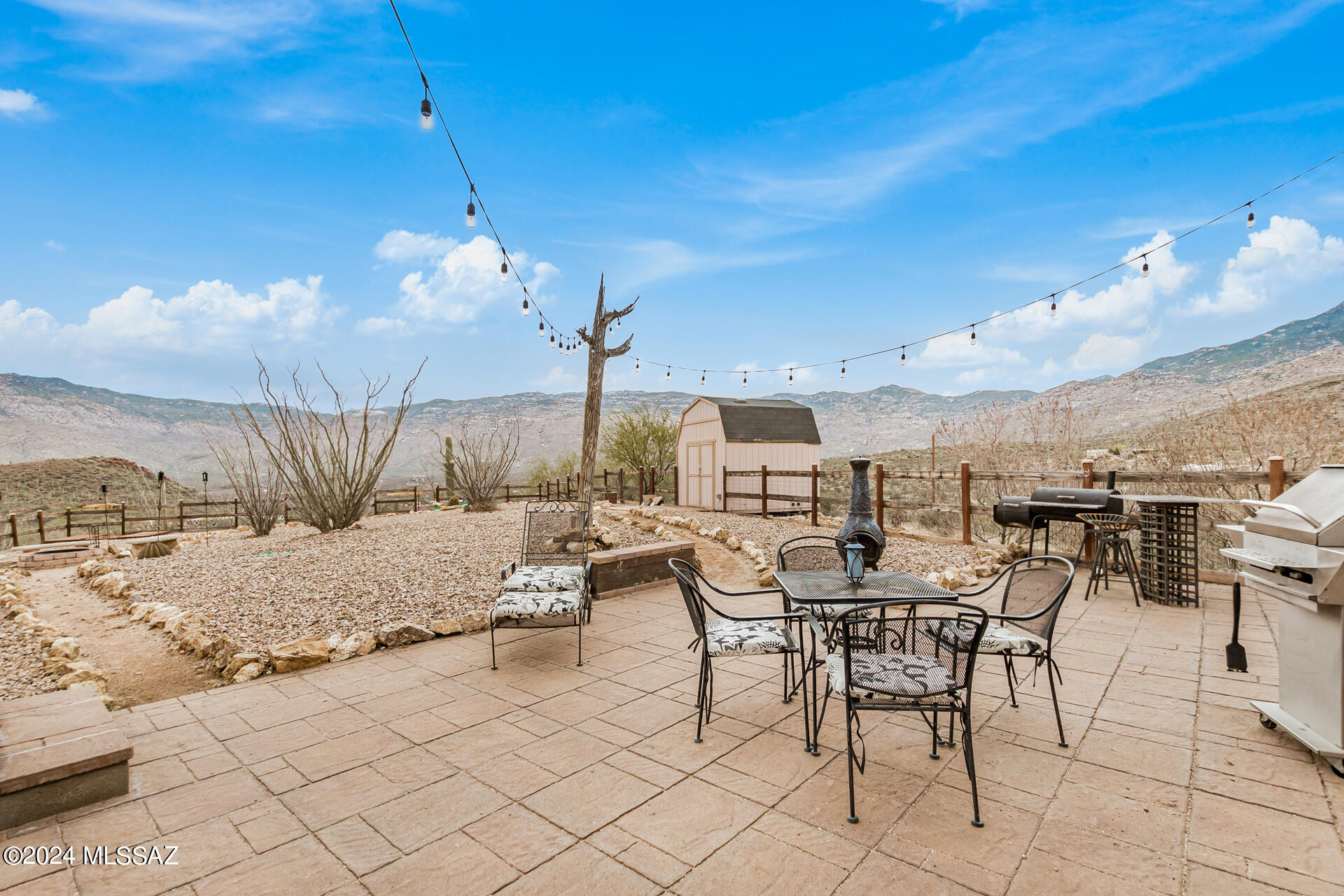 Are you looking for peace and quiet with some of the BEST Mountain views and shining stars that Tucson has to offer? This is it! This 3 bed 2 bath home on almost 5 acres is ABSOLUTELY move in ready and fenced(about 1/4 acre)for your dogs. Bring your toys and telescope, kick back and enjoy the good life. This home has many upgrades. Crown molding, hard wood floors, Thor range, custom wrought iron security doors, a wonderful front patio to watch the sunrises and a spectacular back deck and yard to enjoy the PANORAMIC Mountain views and our incredible Tucson sunsets all while hanging out in the hot tub or while entertaining friends or watching sports on the outside TV. Really, this home has it all. Not a thing was missed when developing the property, many native trees planted all over the property. Many tons of decorative rock brought in, fencing a storage shed and a work shop with electric. The home has a private well. 2 HVAC's, steel roof, 2 car carport.  Did I mention VIEWS??? This is a must see!!!!  Also, this home has an 11kw Genrac generator, if for any reason your power goes out this generator will automatically kick on so you will not be without water or power.