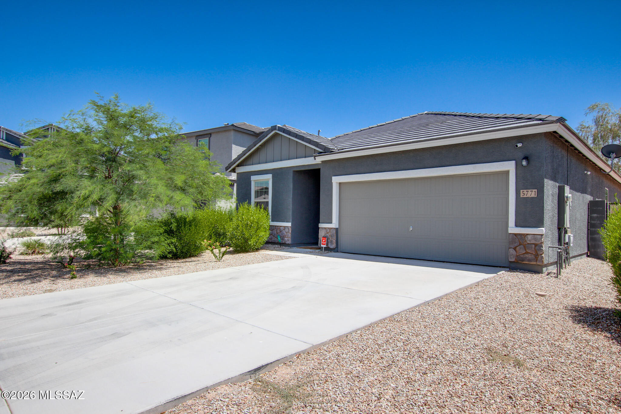 Immaculate 2023 Starlight Homes build in MagicRanch! This beautifully maintained home offers 4 bedrooms, 3 baths, of modern living. The open floor plan connects the kitchen, dining, and great room--perfect for entertaining or relaxing. The kitchens granite countertops, stainless steel appliances, a breakfast bar, and ample cabinetry. Tile flooring runs throughout the main living areas, complemented by custom built ins for added storage and style. The spacious primary suite includes a walkin closet and upgraded bath finishes. Step outside to a landscaped backyard with a covered patio ideal for enjoying Arizona's sunrise and starry nights. Backing to a natural wash, you'll appreciate privacy with no rear neighbors. Energy efficient construction and solar panels help reduce utility costs. Located near Anthem Elementary, this home blends convenience, quality, and pride of ownership in a peaceful community setting.
