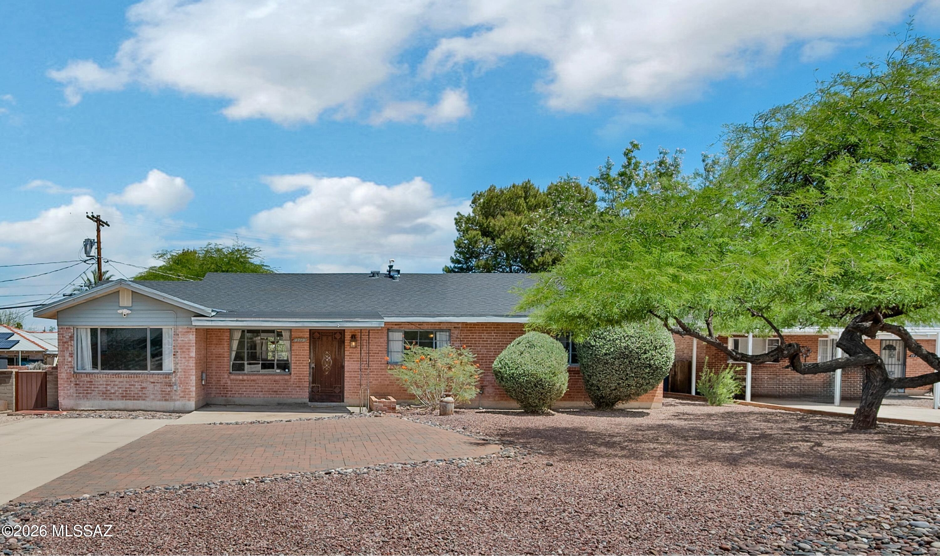 Invest in your future!  Why Rent When You Can Own? This charming brick home in Central Tucson is perfect for first-time buyers. Spanning 1,658 sq. ft., it features 3 bedrooms, 1.75 baths, and dual living spaces (family and living rooms). The large kitchen boasts a gas range, serving island, and dining area, all tied together with easy-care ceramic tile. Major updates provide peace of mind: a newer roof (4 years), PEX re-piping, a tankless water heater, and an included 1-year home warranty. Enjoy a low-maintenance front yard and a private, enclosed backyard. Ideally located near shopping, dining, and Hoffman Park, and just 5 miles from the U of A. Comfortable, affordable living starts here!
