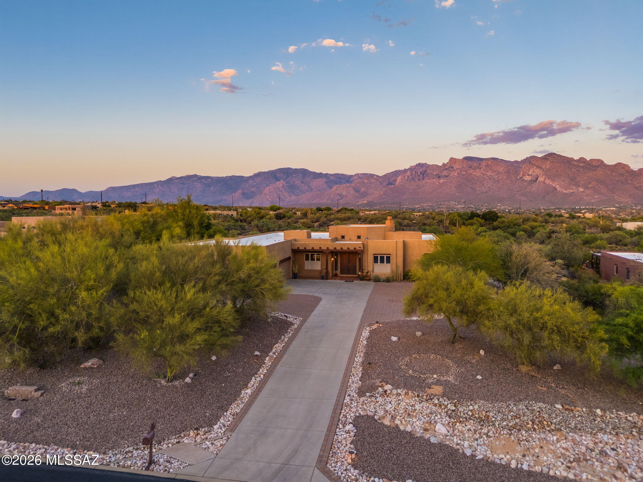 Custom Santa Fe Home on an elevated 1.7 acre private lot offers the beauty and serenity of true desert living.  Surrounded by sweeping, majestic mountain views, this peaceful retreat captures the warmth & charm of the Southwest.  Featuring 4 bedrooms plus a den & office, a private guest suite with its own bath & backyard access, the home blends comfort & flexibility.  The inviting living room showcases high, wood-beamed ceilings & panoramic views, while the open concept kitchen includes a built-in desk & flows easily into the family room - perfect for everyday living & entertaining.  The spacious primary suite enjoys mountain views thru French doors. The large backyard has a pool, spa & custom outdoor shower.  Oversized 3 car garage & paver-accented driveway complete this desert sanctuary.