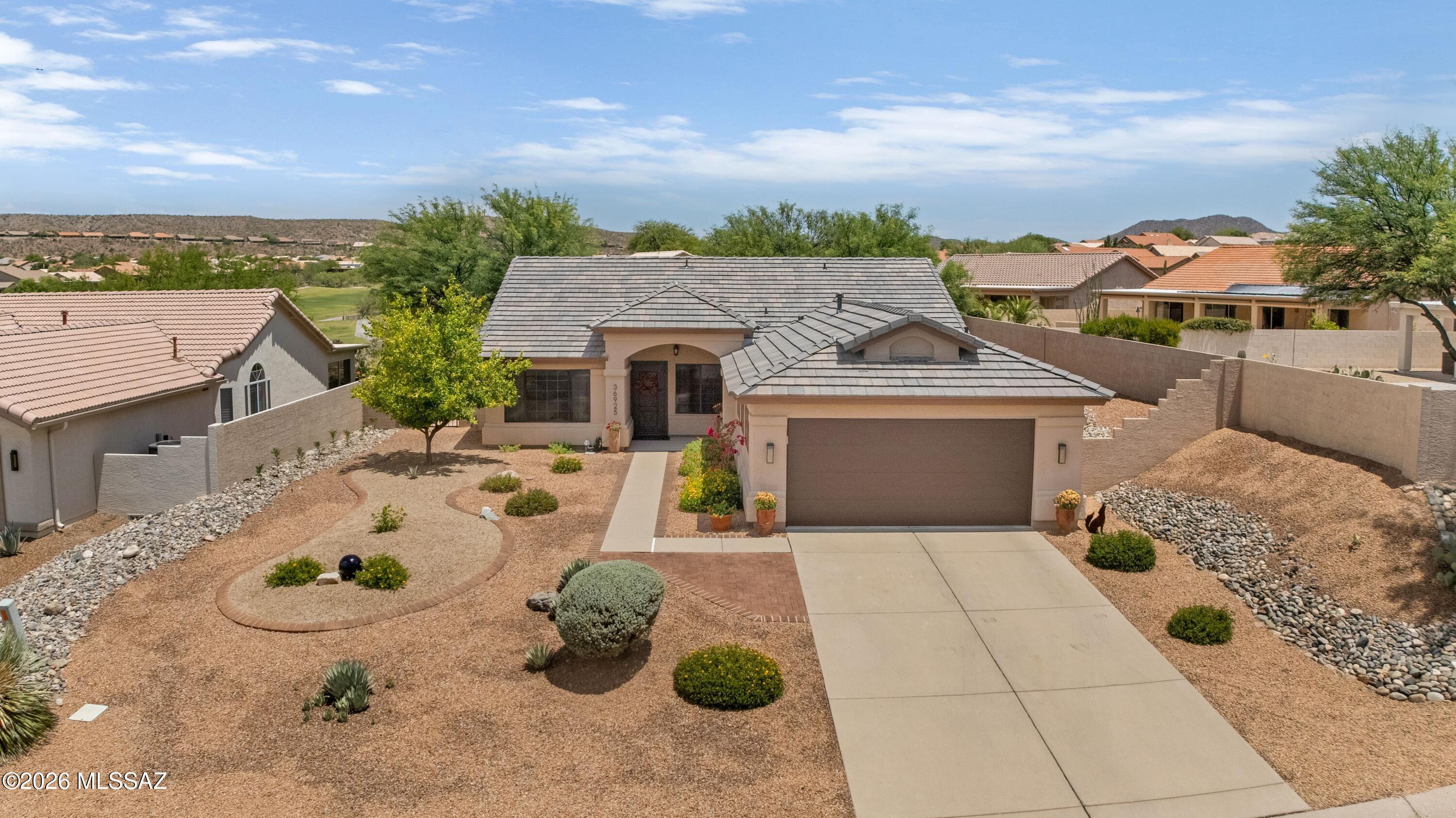 Updated Diego with Golf Course Views! Great curb appeal & Roof underlayment & tiles replaced in 2025. Custom entry door welcomes you into the Living Room & Dining Area. Den/Office. Kitchen features granite counters, stainless appliances, gas range, abundant cabinetry & nook. Family Room offers a built-in entertainment cabinet with electric fireplace & patio slider. Hall Bathroom with jetted tub/shower. Owner's Suite #1 has patio slider, walk-in closet, & ensuite bath with walk-in shower. Owner's Suite #2 has walk-in closet & ensuite bath with walk-in shower. Laundry Room with W/D & cabinetry. Extended 2-car garage with cabinets & W/H 6/2026. Enjoy outdoor living with enclosed paver patio, covered paver patio, built-in BBQ kitchen, lovely landscaping, gated yard, nature & golf course views!