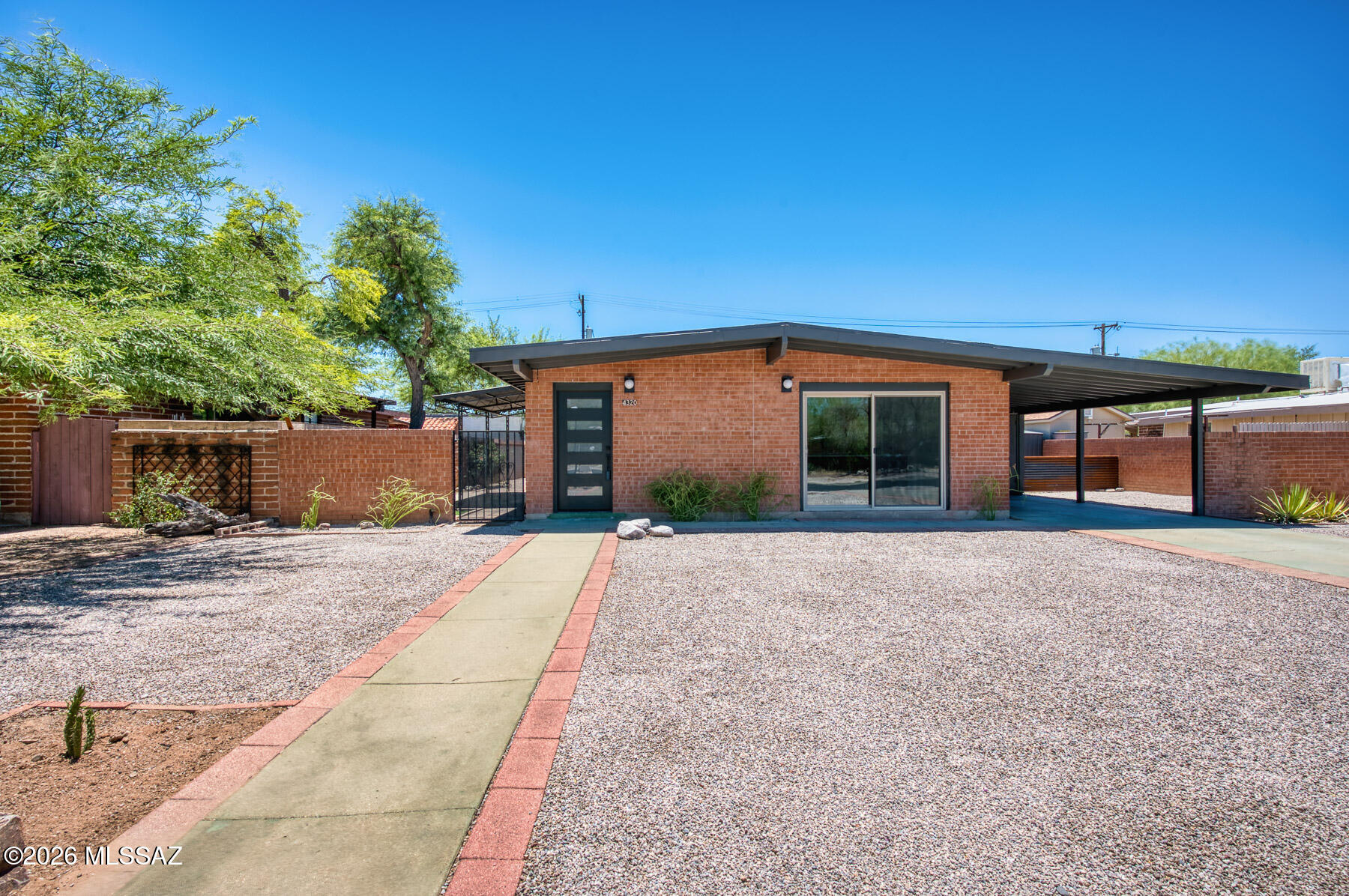 Newly remodeled mid century modern home in desirable central location. Solid red brick exterior with new energy efficient windows featuring 3 bedroom and 2 bathrooms. Fully tiled home for ease of living, freshly painted and new fixtures throughout. The kitchen features modern cabinets with quartz countertops, stylish backsplash and an open design. Both bathrooms have been remodeled with new tile surrounds, vanities, mirrors and lighting. Exterior has a large porch and low care yard with a storage shed. Block wall fencing with alley access.  Agent/Owner