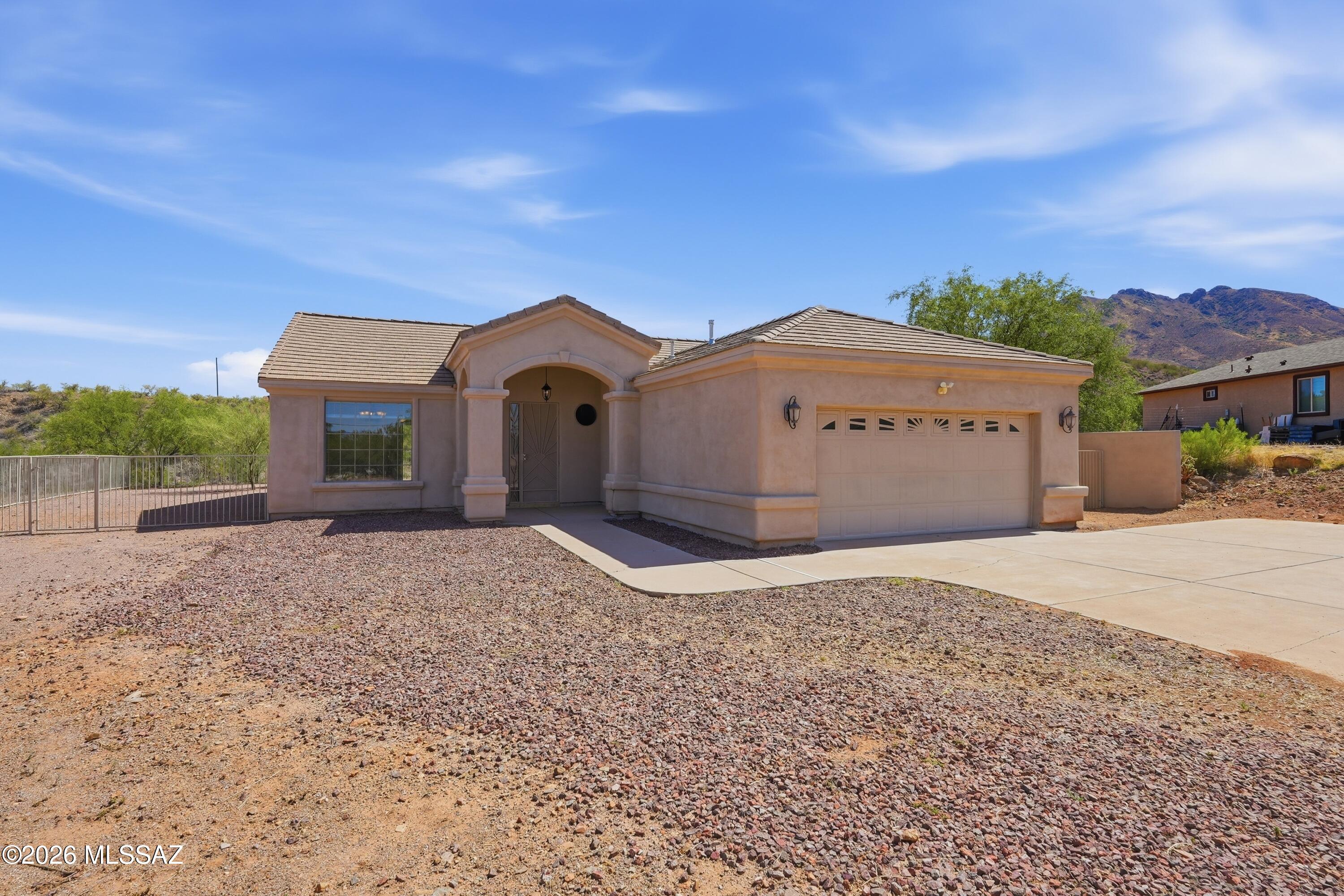 Enjoy beautiful mountain views and AZ sunsets from the living room, breakfast nook, family room, and covered rear patio in this well-maintained 1,834 sq. ft. home on .58 acres. Built in 2007, this split-bedroom floor plan offers 3 bedrooms, 2 full baths, an open living area, ceramic tile flooring throughout, granite countertops in the kitchen and baths, pantry and cabinets with pull-out shelves, breakfast nook, and laundry room with utility sink. Tile roof, enclosed backyard with room for an RV, trailer, or recreational toys, and no HOA. Conveniently located in Ranchettes Unit 17 with quick access to I-19 via Palo Parado Road. Includes the remaining 6 months of an AHS Home Warranty for added peace of mind. Perfect for families who love to entertain--split floor plan, spacious living areas, fenced yard, large covered patio, and beautiful Arizona sunsets! A roomy and perfect home for comfortable living.