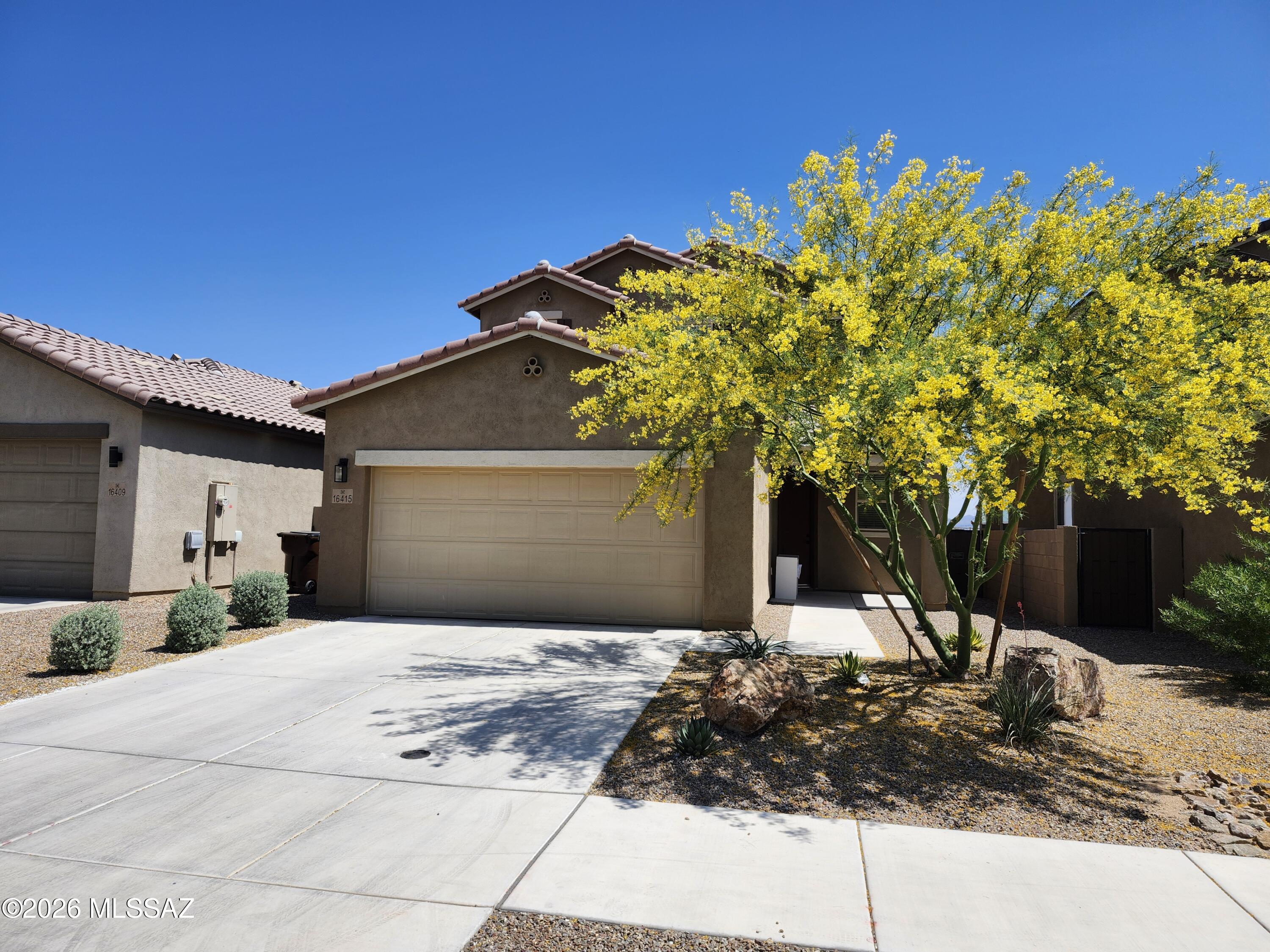 Experience the perfect blend of modern luxury and community living in this spacious 2,170+ sq. ft. home. Located in the highly sought-after Rancho Sahuarita community, this residence offers an exceptional layout designed for both entertaining and relaxation.The Main Level offers an open Great Room Concept with a bright, expansive living area that flows seamlessly into the heart of the home. A Chef's Kitchen featuring a large center island, sleek granite countertops, crisp white cabinetry, and a dedicated TV room/breakfast nook for casual lounging. A sophisticated space perfect for hosting dinner parties or holiday gatherings. Durable, stylish tile flooring throughout the entire ground floor and a convenient powder room for guests. Second level offers a versatile loft space ideal for a home office, playroom, or secondary media center. Primary Suite is a true getaway featuring a trendy sliding barn door that leads to a spa-inspired ensuite bathroom and a massive walk-in closet. All four bedrooms and the dedicated laundry room are located upstairs, keeping your living chores organized and private. Lastly, step out to a covered patio that opens to a beautifully landscaped yard with premium brick pavers and lush artificial turf. Enjoy unobstructed, amazing views of the desert landscape and mountains--perfect for sunset watching.