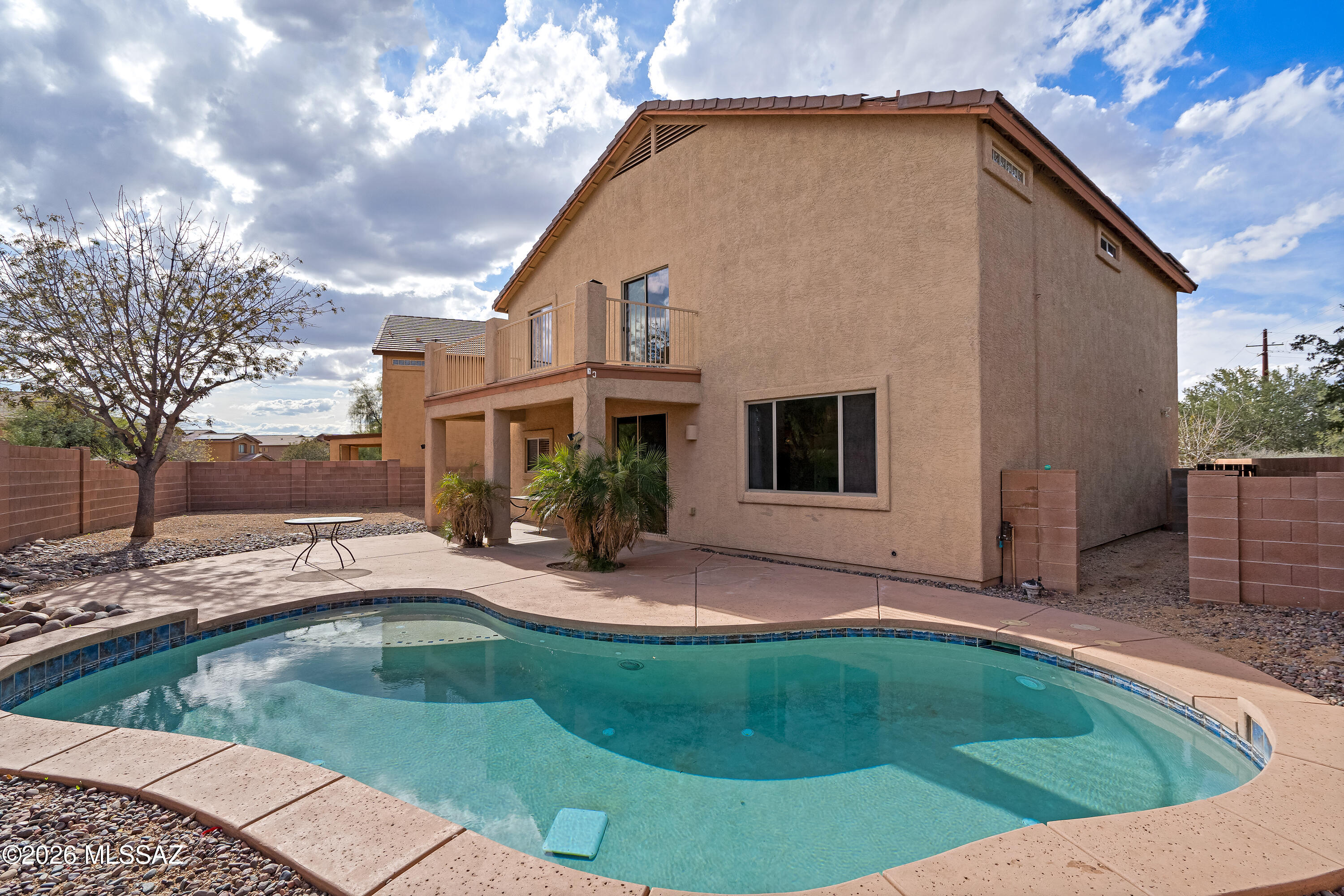 SOLAR PAID OFF AT CLOSING! Tucked in a cul-de-sac, this 4BR/2.5BA home features 2 living areas and a chef's kitchen with Corian tops and a huge walk-in pantry. All bedrooms are upstairs, including a versatile bonus room. The spacious primary suite boasts a barn door entry, desk nook, and a private balcony with mountain views. Enjoy easy-care tile/laminate floors (no carpet!), dual-zone AC, and an upstairs laundry. The backyard is a desert oasis with a sparkling pool and covered patio.  Home is priced to sell.