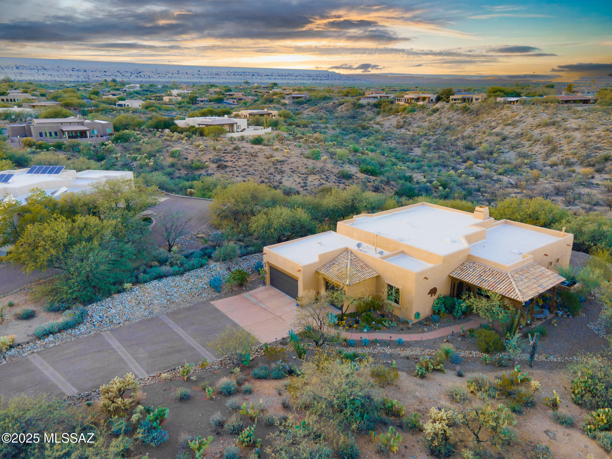 Welcome to this custom residence in the prestigious gated community of Alamos Estate!  Situated on over an acre of Arizona desert landscape, this home makes a striking first impression with its custom wrought-iron entry door, setting the tone for the craftsmanship found throughout.
Inside, you'll find soaring ceilings, exposed wood beams, fresh new interior paint, and a kiva fireplace that adds warmth and Southwestern character to the great room. Abundant natural light fills the home, highlighting its architectural details and open feel.

The beautifully designed kitchen offers a custom glass backsplash behind the stove, a handcrafted hood, a large mesquite island with a built-in wine fridge, stainless steel appliance, granite countertops, and a spacious pantry. The home offers 3 bedrooms and 2.5 bathrooms, providing comfortable living space for family and guests. The guest suite features NEW carpet and a private full bath. A 3-car garage offers ample storage and is big enough for a workspace.

Outside, enjoy the beauty and privacy of the surrounding desert landscape, complete with mature cacti, open views, and stunning Arizona sunsets. Whether entertaining outdoors or enjoying a quiet evening at home, this property offers a peaceful desert setting in one of the area's most desirable gated communities.