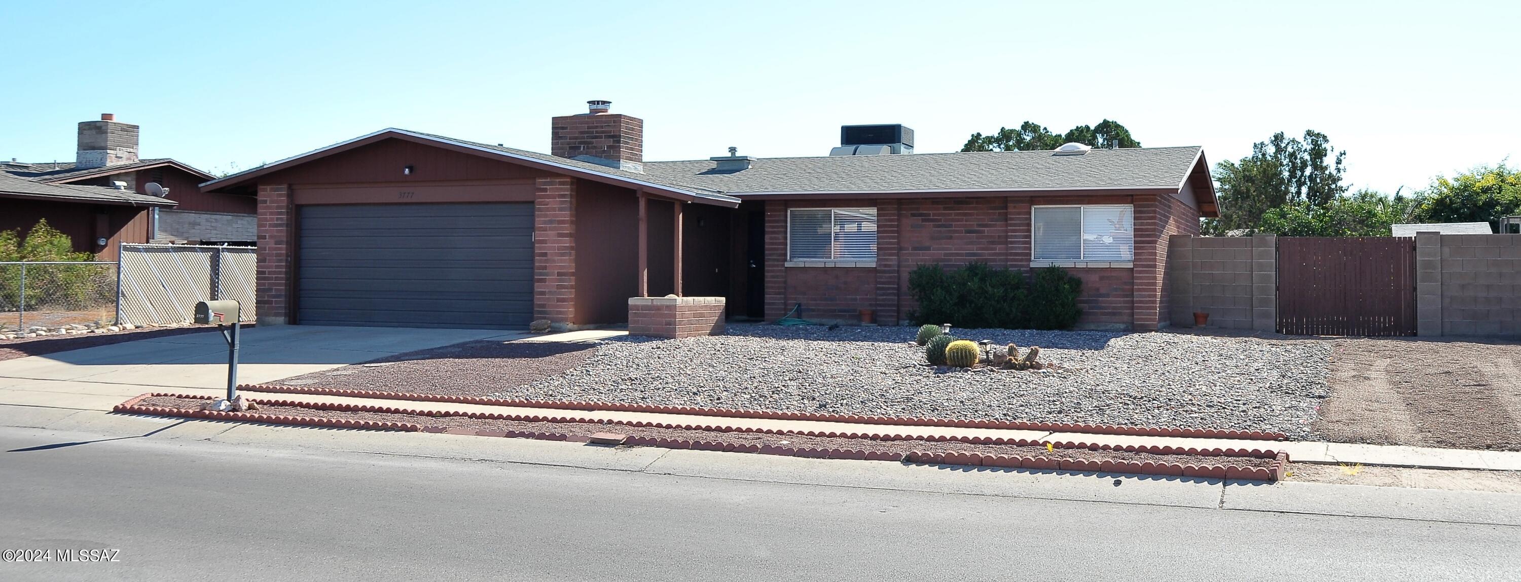 Clean and bright 3 bed 2 bath home on large lot in NW Tucson with no HOA. Wood plank flooring throughout - no carpet! Newer AC & ceiling fans throughout. Bright central kitchen. Dining area off the living room. Family room with cozy wood burning fireplace and solar window screen. Primary bedroom features a walk-in closet and en-suite bath with walk-in shower. Glass slider from the family room leads to a private back yard with covered patio, citrus trees, & storage shed. 2 car garage with laundry (washer & dryer provided). Close proximity to Costco, Home Depot, shopping, & restaurants. One year minimum lease. $45 application fee per adult. Renters insurance required.