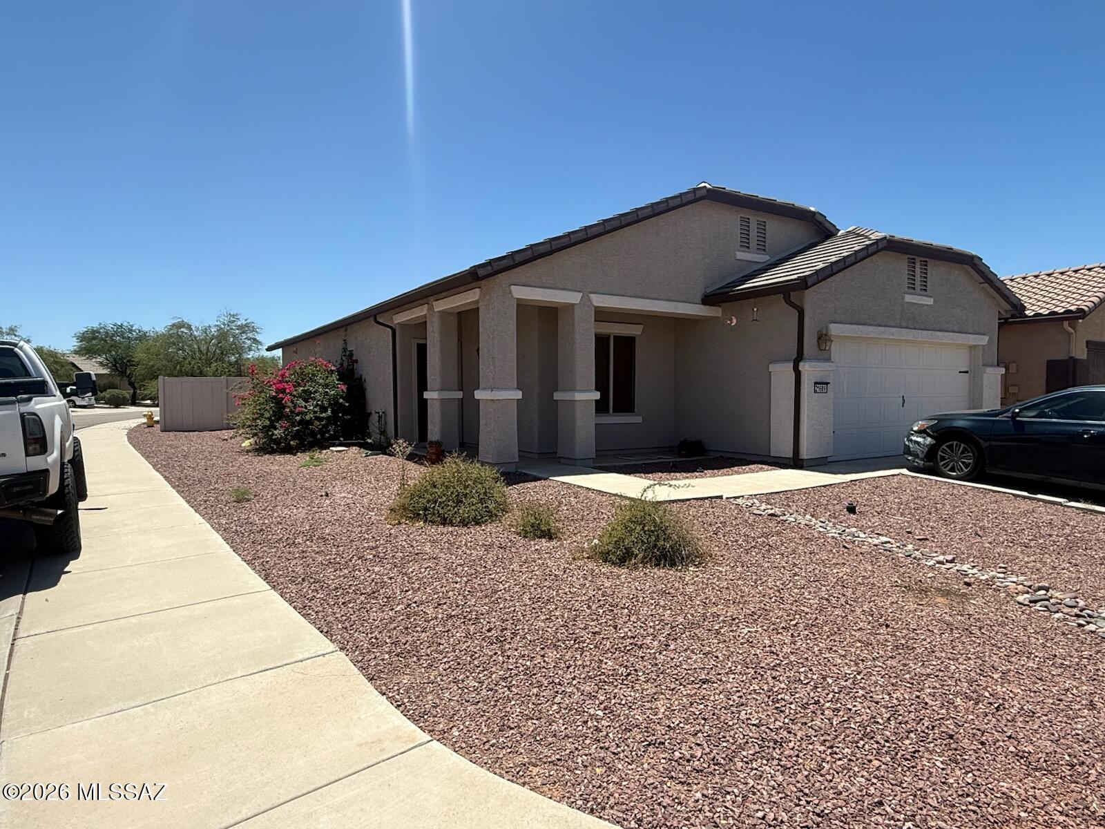 Welcome home to this charming single-story residence located in the desirable Red Rock Village community. Situated on a spacious corner lot, this 3-bedroom, 2-bath home offers 1,605 square feet of comfortable living space with an open-concept floor plan designed for both everyday living and entertaining. The inviting interior features abundant natural light, and a functional layout that seamlessly connects the living, dining, and kitchen areas. The generous backyard provides plenty of space for outdoor activities, gardening, or relaxing under Arizona skies. Residents of Red Rock Village enjoy access to outstanding community amenities, including pools, walking and biking paths, basketball courts, volleyball courts, parks, and athletic facilities. Conveniently located with easy access to Tucson and Casa Grande, this home combines small-town charm with modern convenience. Whether you're a first-time homebuyer, downsizing, or looking for an investment opportunity, this property is ready to welcome you home.