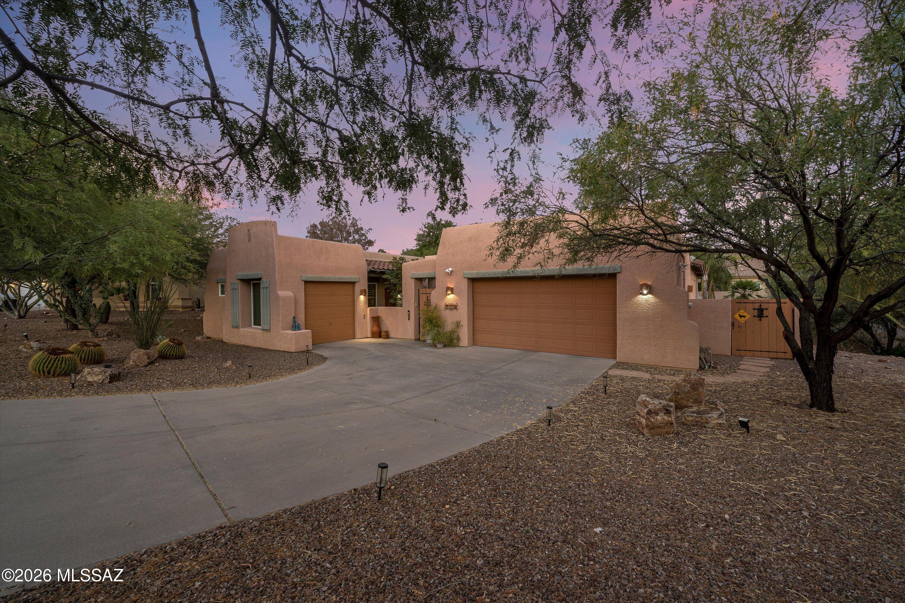 This versatile property offers a well designed 2 bed, 2 bath main home plus a fully equipped 1 bed casita--ideal for guests, multigenerational living, or a private workspace. The main home features a spacious kitchen opening to a large great room, along with a dedicated office with custom built ins. A shaded front courtyard welcomes you, while the generous backyard includes an outdoor kitchen, hot tub, and gas beehive fireplace. The property also provides an attached 2 car garage and a separate single car garage with 20 amp service and air compressor hookups. The casita includes its own bedroom and bath, cooktop, refrigerator, Murphy bed, ample cabinetry, and stacked washer/dryer for fully independent living.