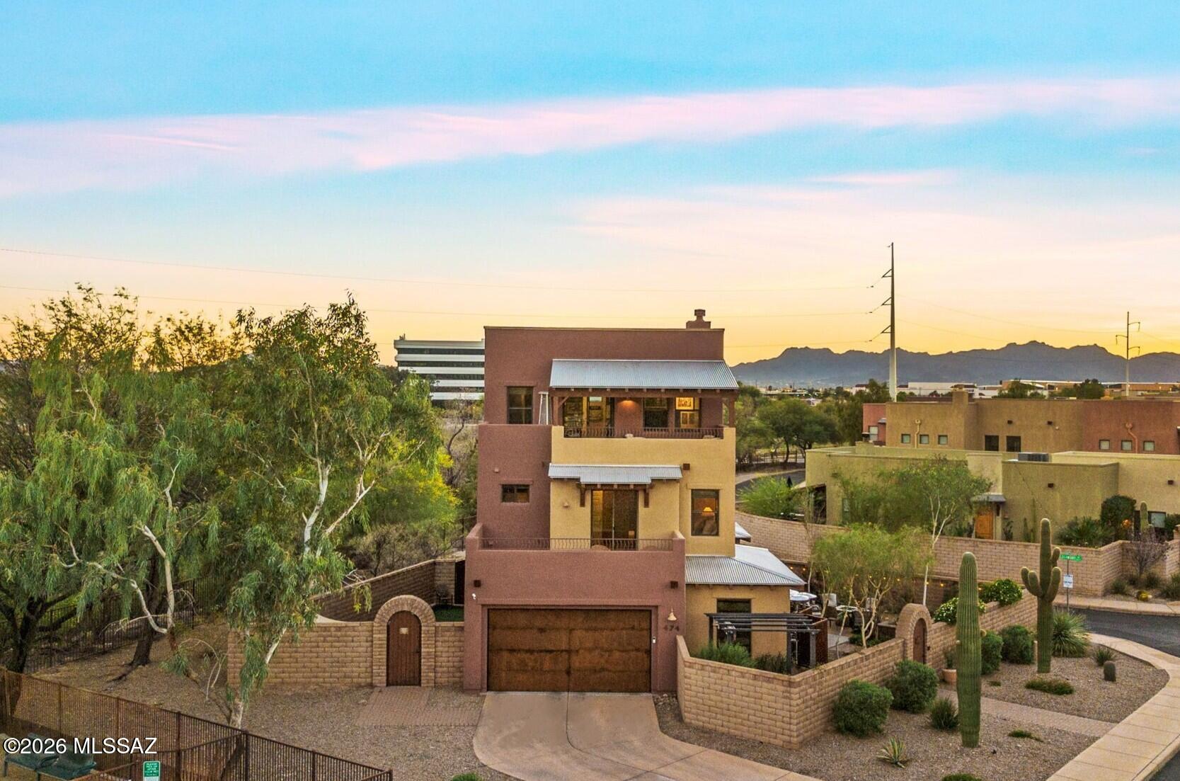 Introducing a refined blend of upscale Barrio-style architecture and urban living within the gated community of Miramonte at the River. Ideally positioned on one of the community's most desirable corner homesites, this residence offers an exceptional sense of privacy and sweeping views in nearly every direction, including the desirable Catalina Mountain vistas. Designed with both everyday functionality and effortless entertaining in mind, the home features a seamless open-concept layout that connects the living, dining, and kitchen spaces into one cohesive, light-filled environment. The main level is thoughtfully arranged, offering a spacious great room, a versatile bedroom currently utilized as an office with a custom built-in desk, and a beautifully appointed full bath with Portinari quartzite countertops, a copper sink, and a walk-in shower with custom glass doors.
At the heart of the home, the gourmet kitchen showcases a curated selection of high-end finishes, including a Perry Luxe custom metal hood, induction cooktop, double ovens, stainless steel appliances, Della Terra Citrine quartz countertops, and an Ann Sacks Artisan Stoneware Clayton tile backsplash. Extensive custom cabinetry, an oversized center island, and a generous walk-in pantry complete the space, delivering both style and functionality.
The primary suite offers a true sense of retreat, privately positioned and enhanced by its own balcony, perfect for quiet mornings or relaxed evenings taking in the surrounding views. The spa-inspired bath features a split dual vanity, soaking tub, separate shower, and dual walk-in closets, along with an additional custom-designed Container Store closet connected to the adjoining bonus space.
Upstairs, a versatile bonus room provides flexibility for a third bedroom, media room, office, or additional living space. This level is complete with a full bath, walk-in closet, cozy fireplace, and an expansive balcony capturing breathtaking mountain views.
Outdoor living is equally impressive, with multiple thoughtfully designed spaces that extend the home's livability. A large, gated courtyard offers several seating areas, a raised bed garden, custom lighting, and mature desert landscaping on a low-maintenance drip system. Just off the kitchen, an additional paver patio creates a perfect setting for outdoor dining. The property also features a well-designed, pet-friendly area with turf, shade, an outdoor sink, and a secure, custom double dog run.
Additional features include solar readiness, passive and recirculating hot water systems, a Tesla charging station, newer HVAC units, updated wood flooring, fresh interior paint, and custom Container Store-designed closets throughout. The home is also built under the TEP Guarantee program, enhancing long-term energy efficiency.
Residents of Miramonte at the River enjoy private access to the Riverwalk (The Loop), along with a year-round heated pool and spa, park with a tranquil fountain, playground, and dog park. Ideally located near local farmers markets, the University of Arizona, and downtown Tucson's vibrant dining and nightlife, this home offers a rare opportunity to experience elevated desert living with urban convenience.