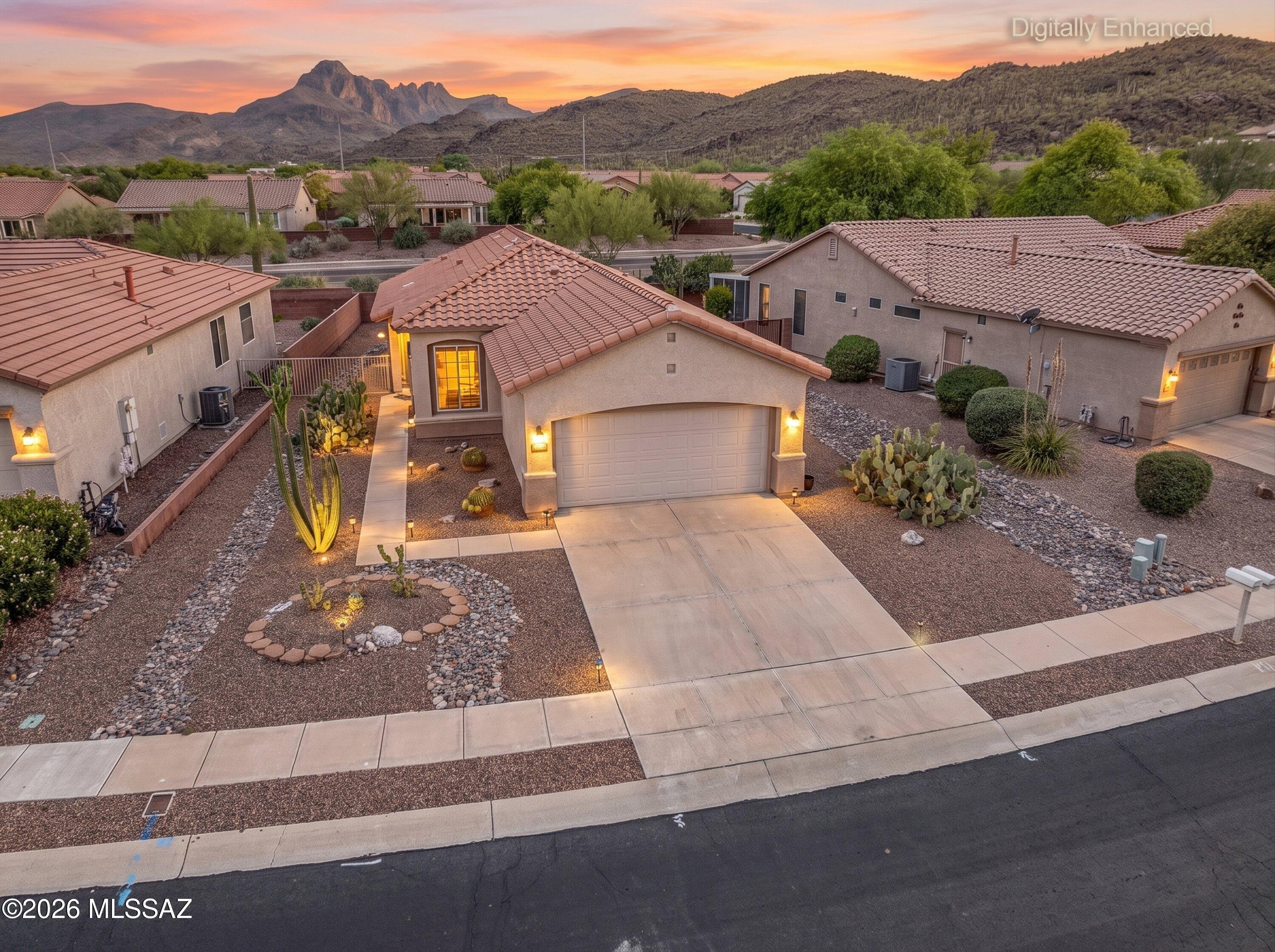This is a rare and gorgeous Sonita model home features great room floor plan with vaulted ceilings. It has beautiful large Large format tile flooring, LVP in bedrooms, Corian counters, Hickory cabinets, custom window coverings, stainless steel appliances, and executive-height bath counters. Enjoy fabulous mountain VIEWS from the patio. No neighbors behind. Make new friends in this popular Active Adult Community, pool/spa, Rec & Fitness center, tennis, pickleball and more! Great location close to shopping, restaurants, El Rio preserve, and Los Morteros Conservation Area.