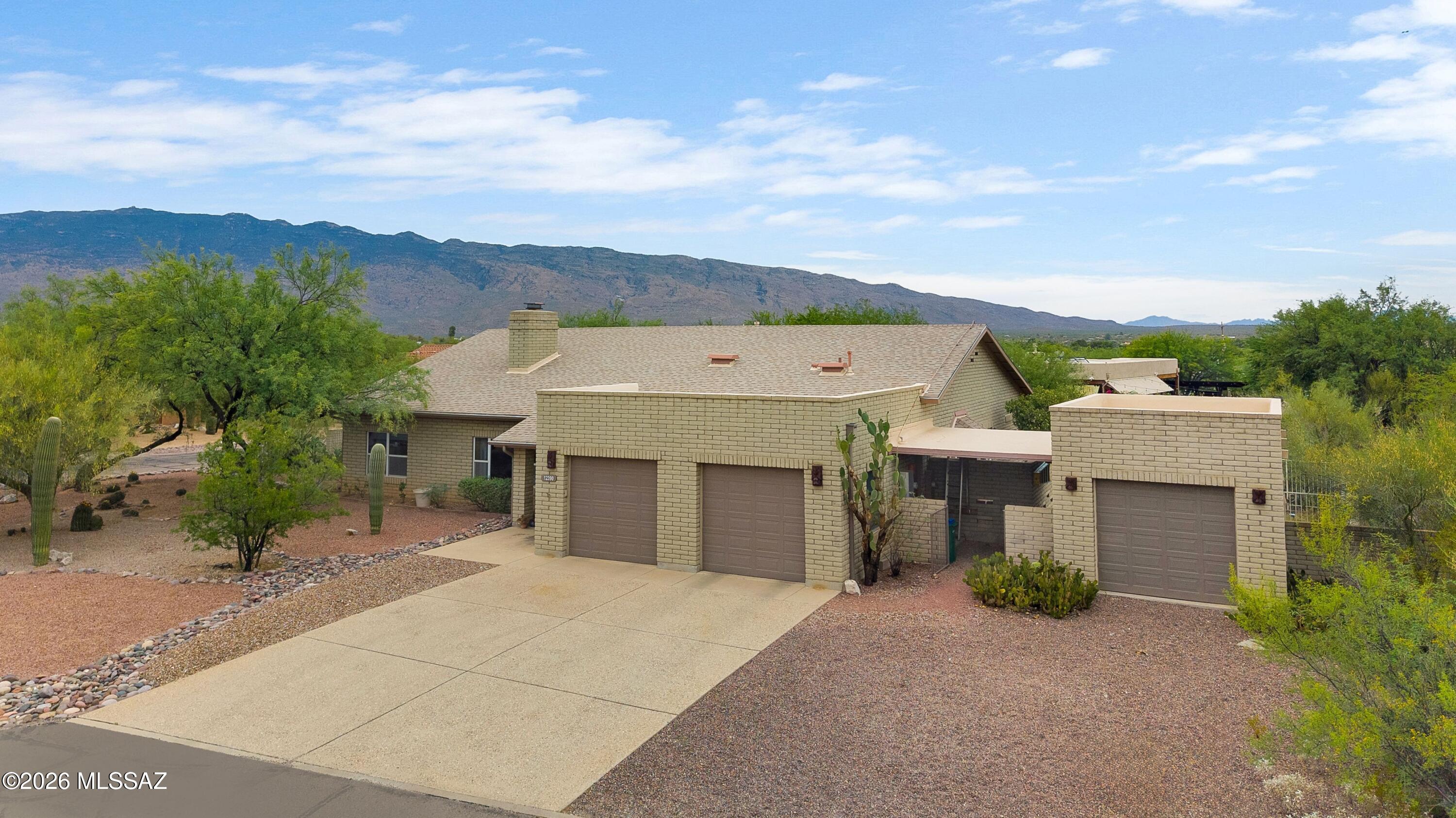 Set on .74 acres in Tucson's scenic northeast foothills, this quality masonry block home offers space, comfort & majestic mt views. Open split bedroom floor plan boasts 3 BR, 2 BA, plus a dedicated office that can easily serve as a 4th BR.  Soaring vaulted ceilings and a striking masonry gas fireplace create a warm focal point in the main living area, while large windows bring in natural light and showcase the surrounding desert landscape. The spacious kitchen offers abundant cabinetry, generous counter space. Outdoors, enjoy a private backyard retreat with a resurfaced pool (2024), hot tub, covered patio, mature desert vegetation, and expansive mountain views. Additional highlights: 3car garage, north/south exposure, prepaid transferable solar PV lease through 2035 & roof replacement 2025