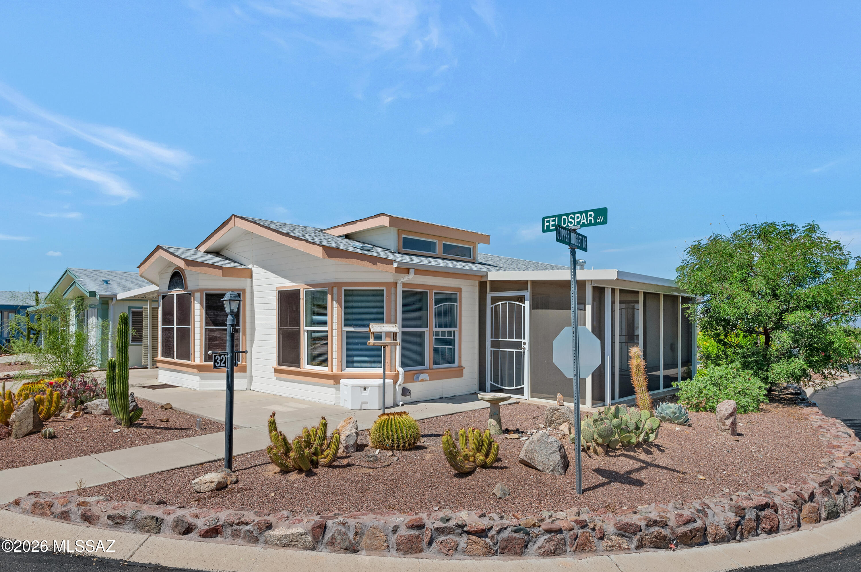 Perched on a premium corner lot in the highly sought-after gated community of Copper Crest, this exceptional Hallmark home showcases some of the most breathtaking panoramic views in the area. Enjoy sweeping vistas of the Sonoran Desert, Tucson Mountain Park, and stunning Arizona sunsets from the comfort of your own backyard. With protected northern views and no buildable lot behind the property, you'll appreciate an unparalleled sense of privacy and open space that is increasingly difficult to find. Meticulously maintained and thoughtfully updated, this 2006 residence offers a versatile floor plan designed for both comfort and functionality. The home features two spacious bedrooms plus flexible bonus room that can easily serve as a home office, hobby room, den, library, or creative workspace to fit your lifestyle. At the heart of the home, the beautifully updated kitchen is sure to impress with granite countertops, newer appliances, abundant cabinetry, and a seamless flow into the dining and living areas--perfect for entertaining guests or enjoying quiet evenings at home. Large windows throughout the living spaces frame the surrounding desert landscape, bringing natural beauty indoors and creating a bright, inviting atmosphere.
Step outside and discover your own private desert retreat. Relax year-round in the screened Arizona room while taking in the magnificent mountain views, unwind in the private hot tub under the stars, or tackle projects and hobbies in the spacious workshop and storage shed. Whether you're hosting friends, enjoying morning coffee, or simply soaking in the serenity of the desert surroundings, this outdoor living space offers endless opportunities to enjoy Arizona's beautiful climate. Copper Crest is a premier Active Adult Community offering an exceptional lifestyle with resort-style amenities that include a sparkling pool and spa, fitness center, clubhouse, walking trails, and numerous social activities. Conveniently located near shopping, dining, golf, medical facilities, and Tucson's outdoor recreation opportunities, this community combines comfort, convenience, and an active lifestyle.
Best of all, unlike many manufactured home communities, you own the land--providing added value, stability, and peace of mind. Opportunities like this are rare. Experience the views, privacy, and lifestyle you've been dreaming of and schedule your private showing today.