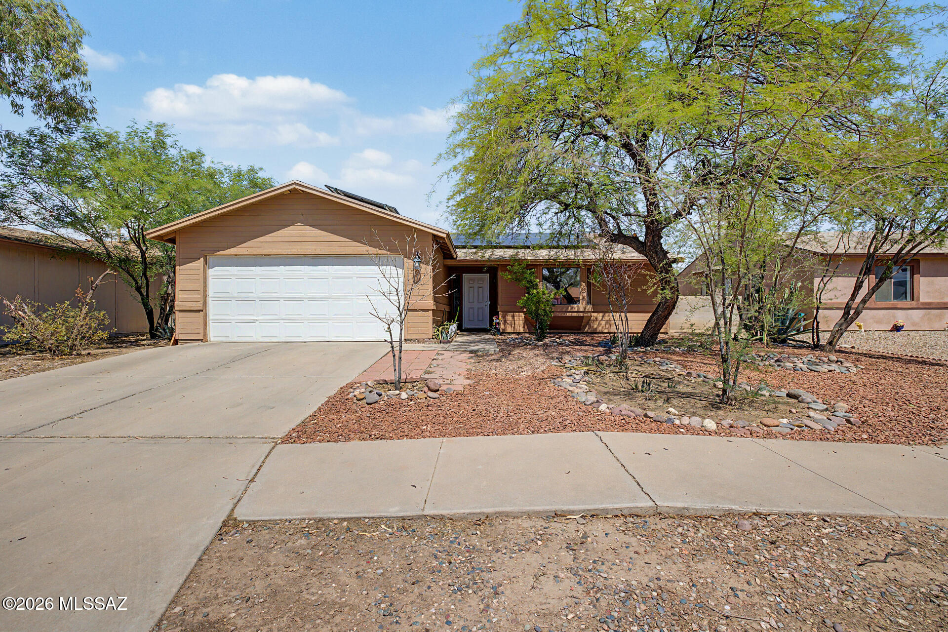Welcome to 5811 S Oaklands Dr, a beautifully maintained single-level home nestled in Tucson's desirable Midvale Park neighborhood. Offering 1,412 square feet of comfortable living space, this inviting residence features 2 bedrooms, 2 bathrooms, and is perfectly situated on a spacious lot. The updated kitchen showcases elegant quartz countertops, creating a stylish and functional space for everyday living. Thoughtful improvements include a new roof installed in 2017 and an HVAC system replaced in 2022, providing added peace of mind. Fully paid-off solar panels installed in 2024 deliver excellent energy efficiency while helping reduce monthly electric costs. Outside, the generous backyard features attractive, low-maintenance desert landscaping, offering plenty of space to relax and enjoy Arizona living. Ideally located near shopping, dining, parks, major routes, and everyday conveniences, this home is a wonderful opportunity you will not want to miss.