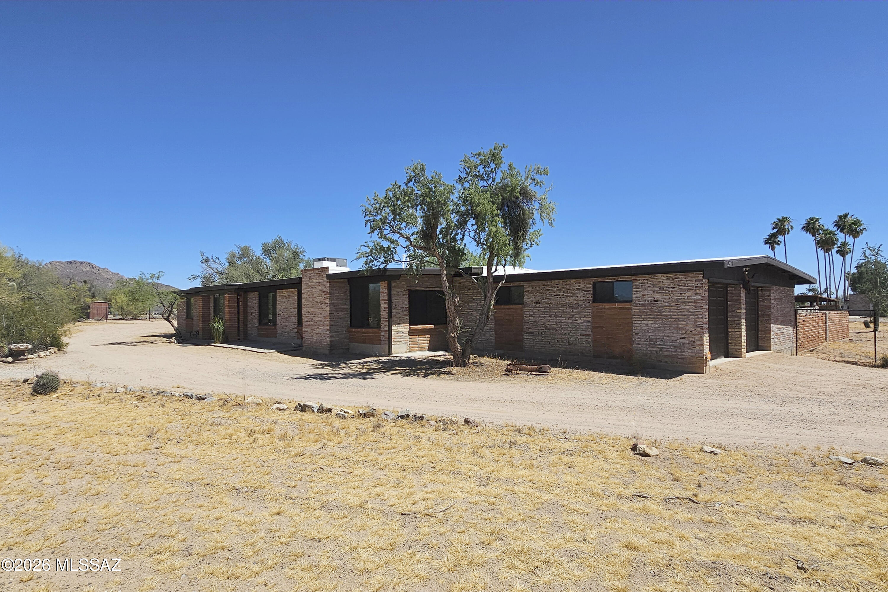 Rural living on large 3.35acre corner lot in an updated 1973 ranch style home. If you enjoy a more rural feel (but also like paved roads), this is a great area! This 'Old West Ranchettes' community has generous lot sizes and hugs the saguaro national park. Over 60 mature saguaro cactus on site. The entire house was remodeled in late 2024, so the only work to be done is moving in. The garage has a bonus side space and storage closet. Flat space is available to add horse facilities or other structures. Handicap accessibility ramps are present, but can be removed depending on buyer's needs.