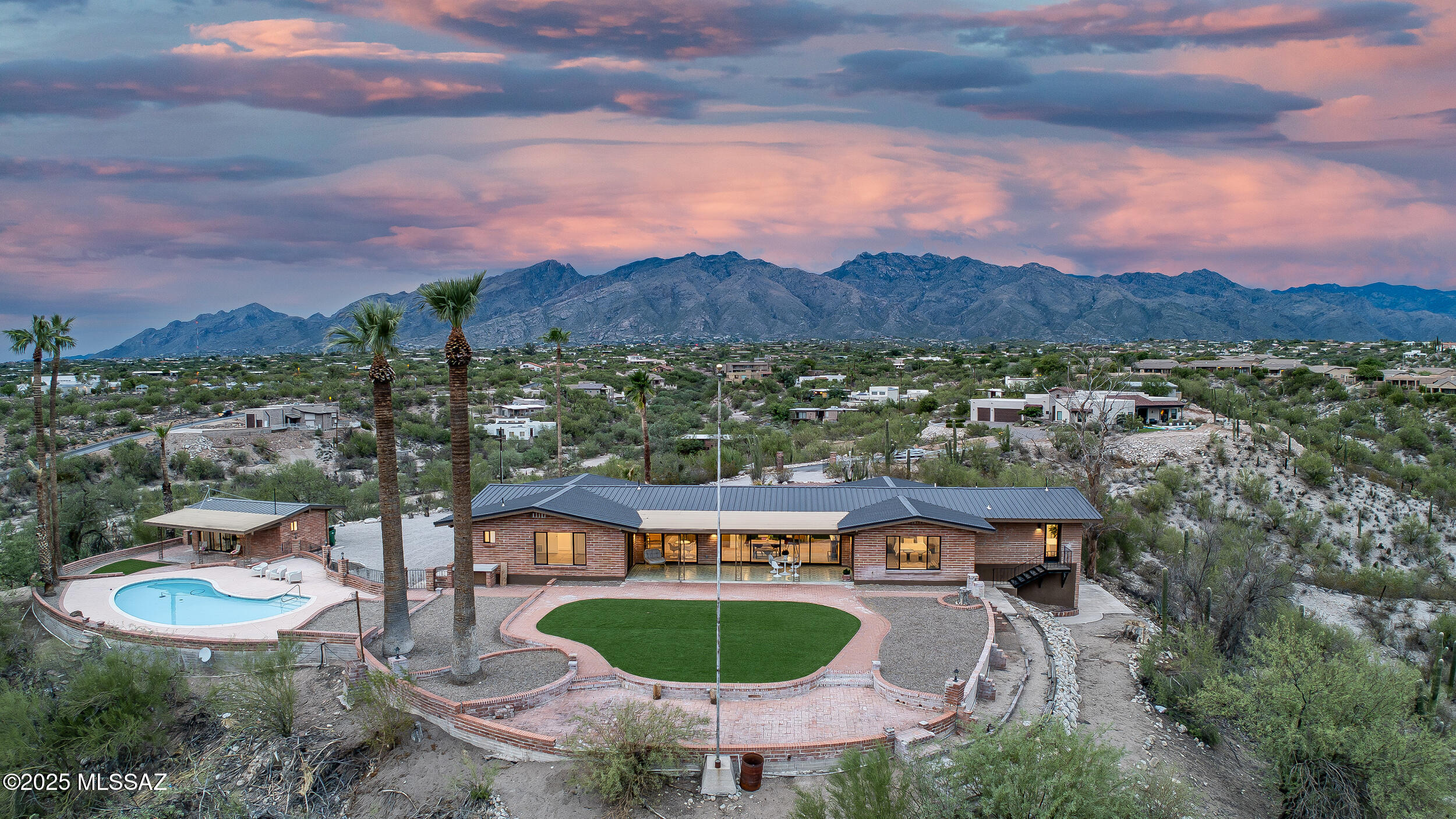 Luxury Live Auction! Bidding to start from $1,100,000.00! Exquisite 3.5-acre estate in the heart of Tucson featuring a fully remodeled 2,801sqft main home with 2 car garage, 743sq guest house, and 375sq pool house. Modern upgrades include new metal roof, new AC units and mini splits, all new appliances, and fully remodeled with refined finishes throughout. The main home offers 3 ensuite bedrooms + powder room, a gourmet kitchen, great room with sweeping city views, and formal living with fireplace looking out at mountains you feel you can touch! Walls of glass concept open to an extended covered patio overlooking the pool, desert, turf yard, and Tucson skyline. Pool house opens to the shared backyard retreat for in-laws or adult kids. Guest house enjoys its own driveway, laundry, and patio. A rare blend of privacy, views, and luxury. New septic!