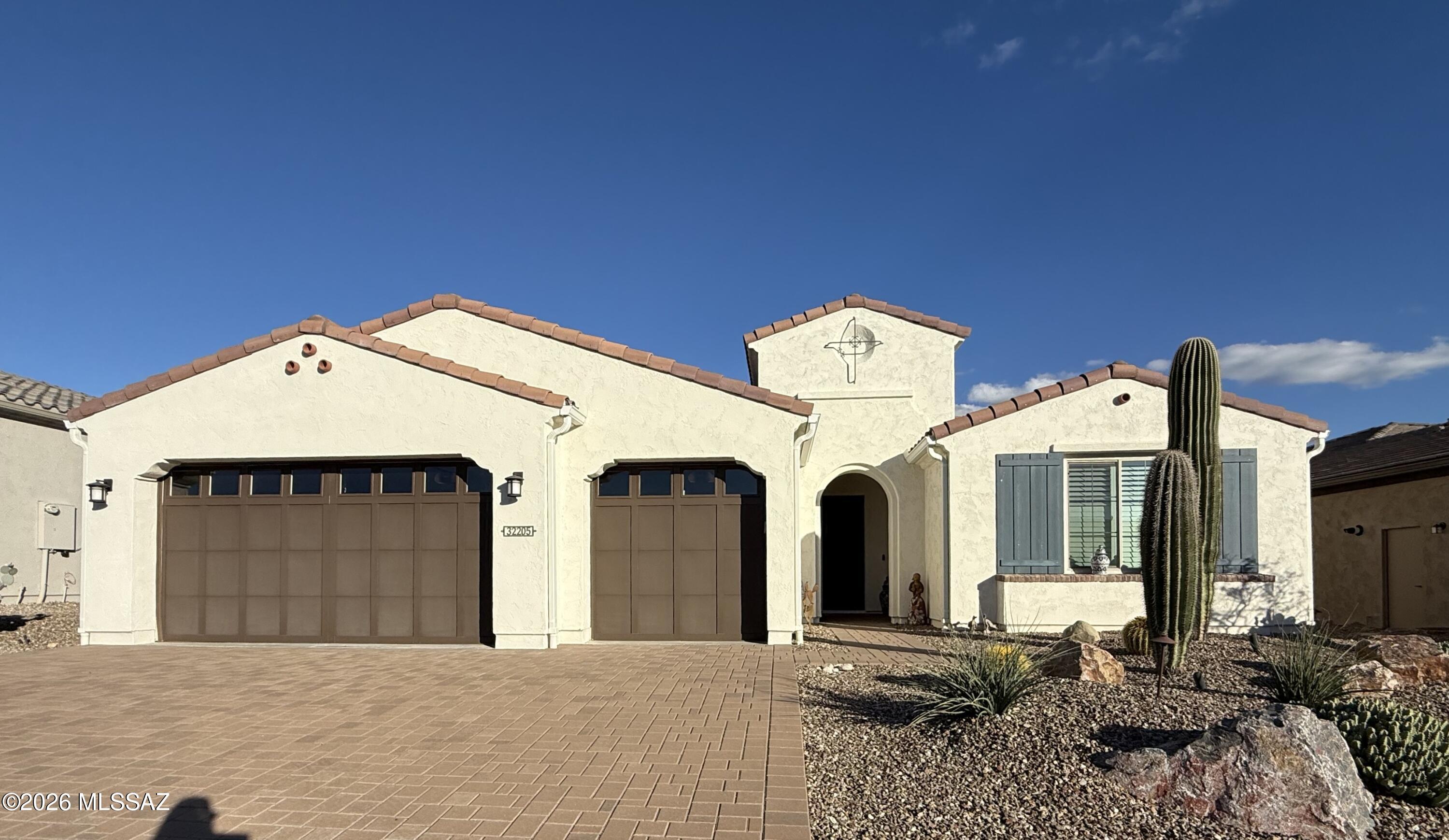 This stunning golf course home in SaddleBrooke Ranch is rich with high-end finishes. The sought-after Vienta floor plan offers 2 bedrooms and 2.5 baths with an open-concept living, dining, and kitchen area that impresses with a wall of stackable sliding doors, custom ceiling beams, a cozy fireplace and bar area with wine cooler. The chef's kitchen is beautifully appointed with Wolf appliances, an oversized island, quartz countertops, and a spacious walk-in pantry—perfect for entertaining or everyday living. A den with double doors and custom built-ins provides an ideal home office or private retreat. Step outside to enjoy morning coffee by your own putting green and unwind in the evenings by the outdoor fireplace, all while taking in breathtaking views of Mt. Lemmon. Completing the home is an extended, climate-controlled 3-car garage, outfitted with two upright wine coolers, perfect for collectors and entertainers alike. The primary suite offers exceptional comfort and style, featuring an oversized zero-entry shower, dual sinks with a dedicated makeup vanity, an extended walk-in closet, and a spacious bedroom enhanced by blackout shades and light-filtering curtains. The secondary suite includes its own walk-in closet and a beautifully custom-tiled tub/shower. Ample storage is found throughout the home. Don't miss the opportunity to make this exceptional property yours today.