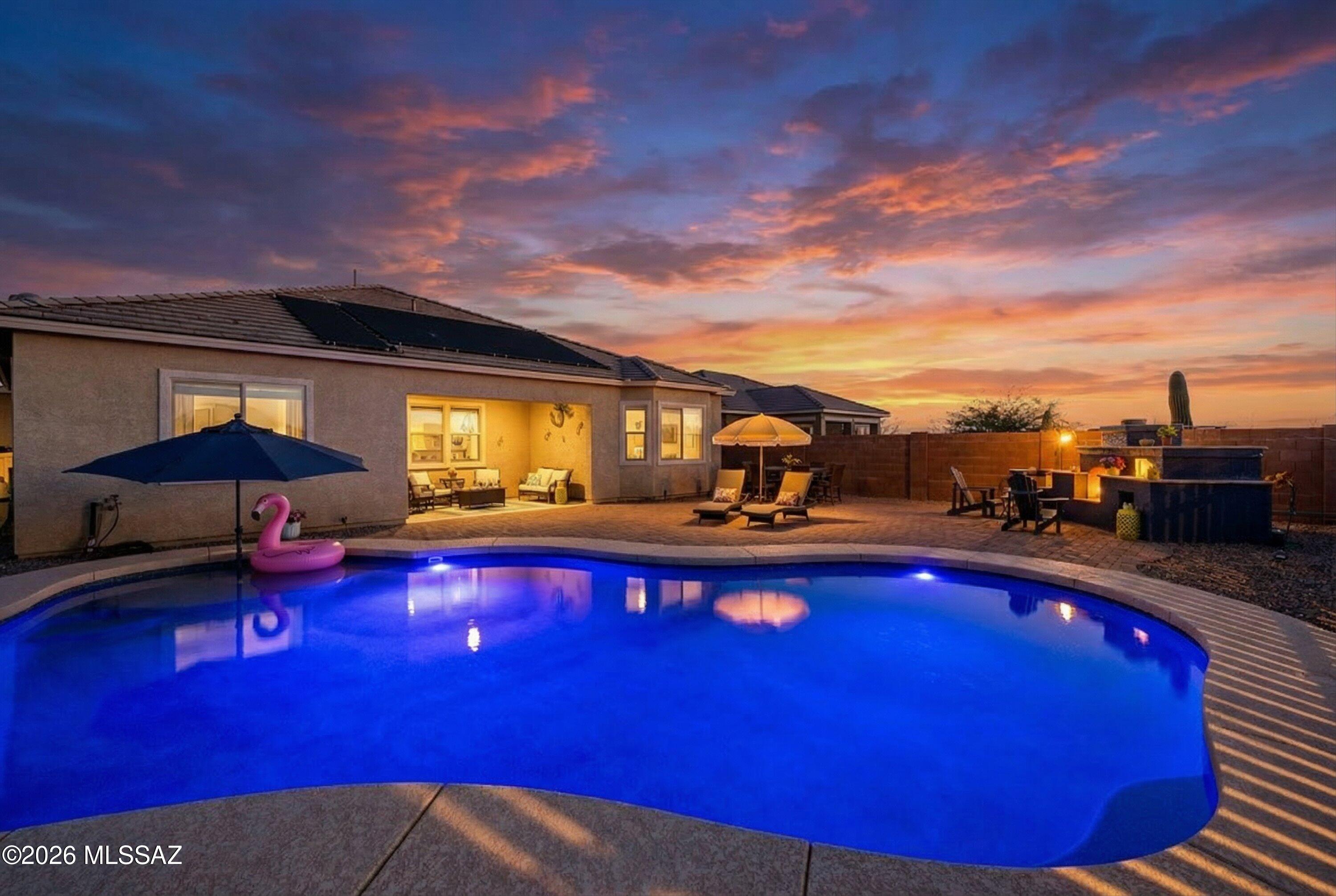 Top Rated Vail School District, Single Story, 3 Car Garage, Solar Heated, Pebble tec pool!

Welcome to a home that is out of this world! If you've been searching for more space, more beauty, and a place where everyday living feels a little extraordinary, this remarkable property in the highly sought-after community of Sycamore Canyon may be exactly what you've been waiting for. Surrounded by spectacular desert sunsets and breathtaking mountain views, this community offers walking paths, scenic trail systems, and a beautiful neighborhood park, creating the perfect setting for both peaceful mornings and vibrant outdoor living. From the moment you arrive, you'll be greeted by a three-car garage and welcoming curb appeal that sets the tone for the stunning interior that awaits. A custom wrought iron security door and gate open to reveal a thoughtfully designed home filled with warmth, style, and comfort. Inside, neutral tile plank flooring flows throughout the main living spaces, creating a clean and elegant foundation for everyday life, while the bedrooms feature upgraded carpet for added comfort and warmth.
Just off the entry is a beautifully sized den with custom doors, offering the ideal space for a home office, play space, or quiet retreat. The home then opens into a spacious open-concept living area where the family room and kitchen come together effortlessly, perfect for entertaining guests, hosting celebrations, or simply enjoying time together.
The kitchen shines as the centerpiece of the home. An oversized square island topped with neutral granite countertops anchors the space, complemented by dreamy cream-colored cabinetry, a stunning blue subway tile backsplash, and an oversized gas range ready for culinary creations. For those who love to cook, organize, and entertain, the two walk-in pantries provide exceptional storage and convenience. A dining area just off the kitchen creates the perfect place to gather for meals and memorable moments.

Step outside and prepare to be amazed. The backyard is nothing short of a showstopper, featuring a solar-heated PebbleTec pool and the rare luxury of no back neighbors, allowing you to soak in the quiet beauty of the desert landscape. As the sky transforms into those unforgettable cotton-candy Arizona sunsets and the Mica Mountain views stretch across the horizon, the outdoor living space becomes a destination all its own.
Designed for unforgettable evenings and weekend gatherings, the backyard also includes a wood-burning fireplace, wood-fired pizza oven, and a Santa Maria-style grill with a hand-crank adjustable grate, creating the ultimate outdoor cooking and entertaining experience.
Back inside, the home continues to impress with a spacious primary suite, a junior primary, and three full bathrooms plus a convenient half bath, allowing both privacy and flexibility for guests or multi-generational living. An extra-large laundry room adds practicality to everyday life while maintaining the home's thoughtful design.

With its remarkable layout, stunning finishes, incredible outdoor living spaces, and unbeatable location, this home truly feels written in the stars. A place where comfort, beauty, and lifestyle come together, this is more than a house. This is home