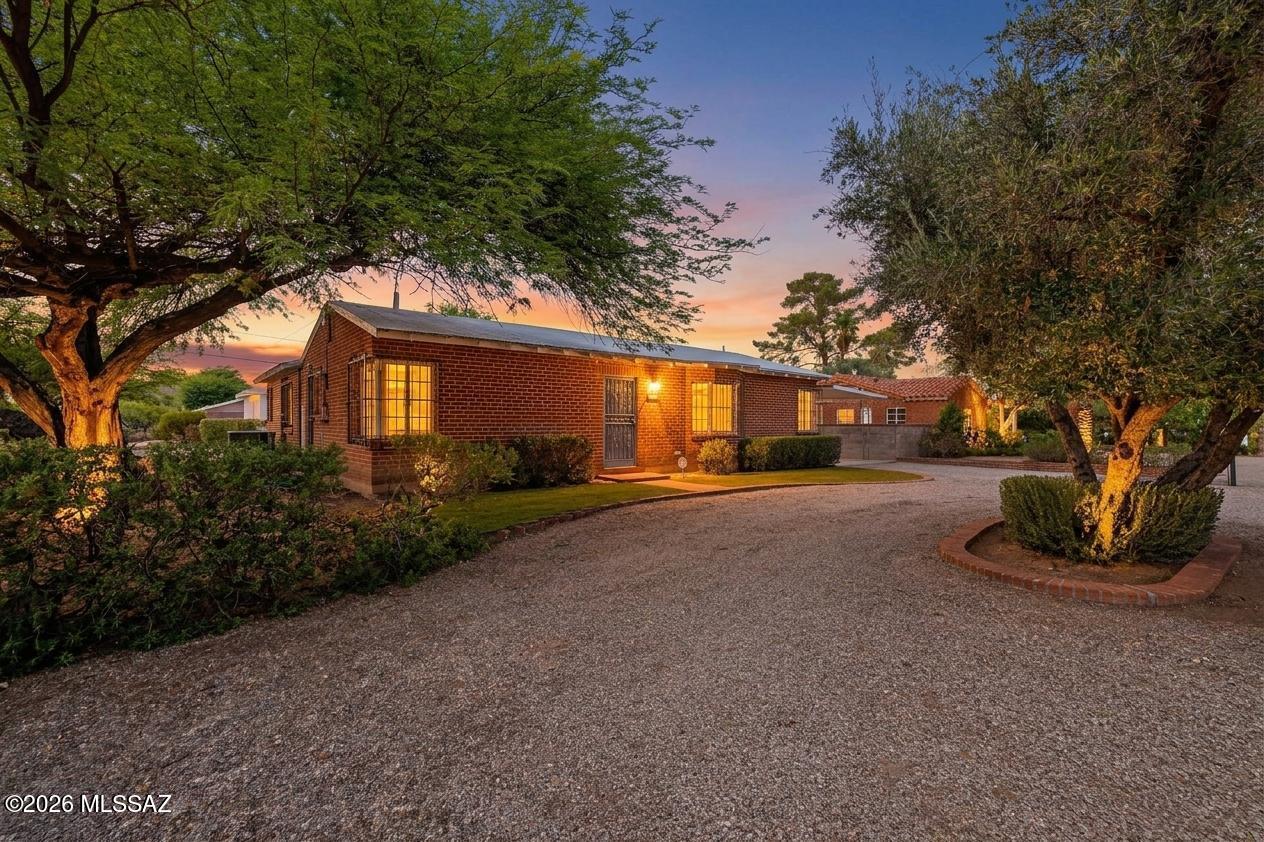 Unique opportunity to own a move-in ready registered historic 1,722 SqFt, 3 bedroom/2 bath, split floor plan, single-story 1954 wire-cut red brick Mid-Century Modern ranch on a premium .27-acre R1 corner lot with no HOA, located in the highly desirable historic Catalina Vista neighborhood in Central Tucson.
Designed by renowned Tucson architect Anne Rysdale and built by Al Hubbard for the original family owners, this remarkable home showcases exceptional pride of ownership throughout. Offered for sale for the first time since 1954, this historic home is filled with the timeless character and charm that never go out of style, capturing the warmth, craftsmanship, and authenticity of a bygone era. Homes with this kind of history and provenance rarely become available. Sold as-is and priced below a recent $575K appraisal.
Featuring desirable east/west orientation, Catalina Mountain views, a circular driveway, 216 SqFt covered carport, ample on and off-street parking, mature landscaping, and metal security bars on all windows and doors.
Inside, buyers will appreciate painted textured ceilings (no popcorn), vintage windows and original hardware, skylights that fill the home with soft, diffused natural light, an alarm system, gas HVAC with digital thermostat, ceiling fans, and an internal laundry room with washer and dryer included. The massive living room showcases beautiful hardwood plank ceilings and the warm glow of the home's original vibrant tile, while the separate family room and formal dining area with a swinging butler door create inviting spaces for both everyday living and entertaining.
The updated kitchen blends modern convenience with the home's original character, featuring luxury plank flooring, updated cabinetry, a white appliance package including gas cooktop, exhaust hood, oven, microwave, refrigerator with ice and water dispenser, dishwasher, double metal sink beneath a garden window, garbage disposal, an additional prep sink, and expanded pantry cabinetry.
Step outside to enjoy peaceful Tucson sunsets beneath the extended 237 SqFt covered patio with exposed aggregate concrete, surrounded by mature landscaping, brick pavers, and block privacy walls. The detached artist's studio/workshop with power offers endless possibilities and could easily be converted into a guest house, exercise room, or home office. As a registered historic home and primary residence, owners also benefit from reduced property taxes.
Desirable Central Tucson location within walking distance of Snooze, Dante's Kitchen, Culinary Dropout, Kingfisher, Catalina Vista's Tahoe Park, historic Arizona Inn and Himmel Park, a 24.3-acre urban park featuring a swimming pool, eight lighted tennis and pickleball courts, two playgrounds, a grass amphitheater, the Himmel Park Branch Library (currently under construction), and expansive open fields large enough to accommodate four full-size soccer fields. Just minutes from Banner University Medical Center, the University of Arizona, shopping, restaurants, and everything Central Tucson has to offer. 
Historic Catalina Vista platted in 1940, Catalina Vista is a 170-acre midtown historic district located between Grant Road, Elm Street, Campbell Avenue, and Tucson Boulevard. It is celebrated as Tucson's first unified suburban neighborhood designed explicitly for the automobile, featuring wide, curvilinear palm-lined streets, landscaped medians, and custom single-story Ranch homes. 
Located on the former grounds of the Kramer Ranch and Tucson's first polo field and rodeo grounds. Centered around circular Tahoe Park, which features a baseball field, playground, historic markers, and an antique roof-tile ramada for community gatherings. It is highly walkable and bike-friendly, located just a half-mile from the University of Arizona, the Banner Health Sciences Center, and the eastern terminus of the Sun Link Modern Streetcar line. 
Developed during the 'City Beautiful' era, the neighborhood was purposefully designed with curvilinear streets, traffic roundabouts, landscaped medians, and wide, shallow lots to accommodate the modern vehicle rather than streetcars. 
Call today to schedule your private showing of this truly special historic home.