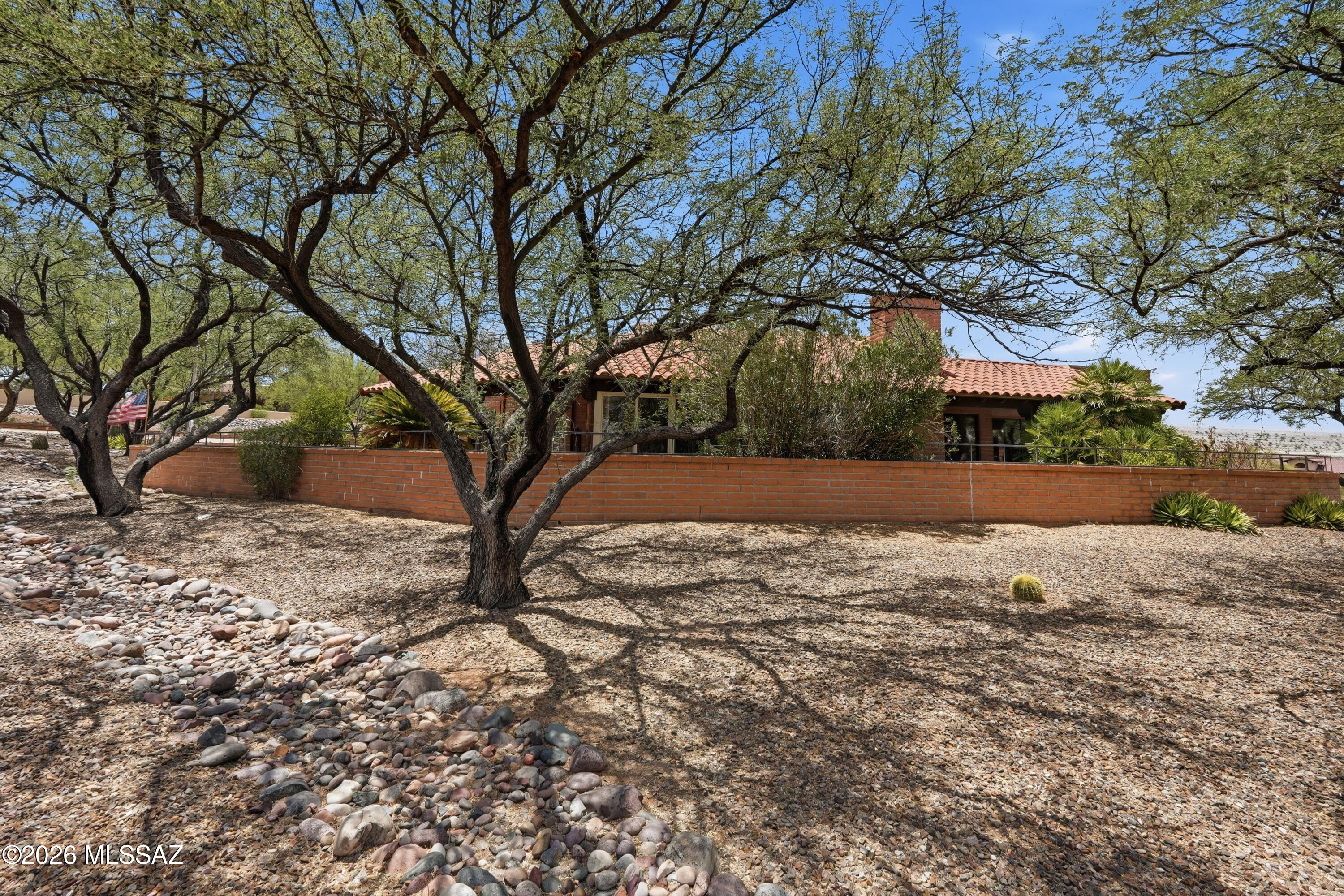 Secluded custom home area on 1.1 acre  2 BR 2 BA plus office and spacious Arizona room.  Wonderful blend of comfort, convenience and Southwest charm.  Large grand foyer opens into large living room with fireplace and wet bar.  Open kitchen with large informal dining area.  Separate formal dining area.  Huge primary suite with access to private back patio with views of the mountains.