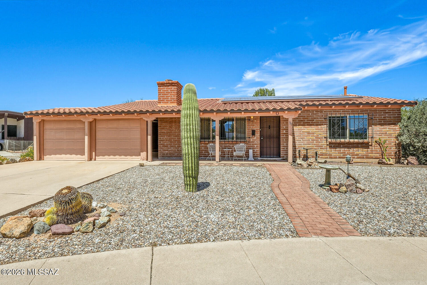 Move right in to this charming furnished home in the well-established Fairways 3 neighborhood.  Situated on a quiet cul de sac with Santa Rita mountain views!   Plenty of room outside on your 1/5 acre lot. Owned solar panels mean low monthly electric bills!  Roads are county-maintained which makes for a very low HOA annual fee of $60!!  Enjoy cozy winter evenings by the brick fireplace in the living room.  The adjoining light-filled Arizona Room could be the tv room or a wonderful art studio!  Separate Laundry room off the Arizona room with plenty of storage.  Also a separate-entry workshop-storage on the back of the home,.  Stunning wood-like porcelain tile in both bedrooms!  Lots of room outside in the back yard for entertaining.  You are linked to the famed De Anza Trail.  Enjoy!
