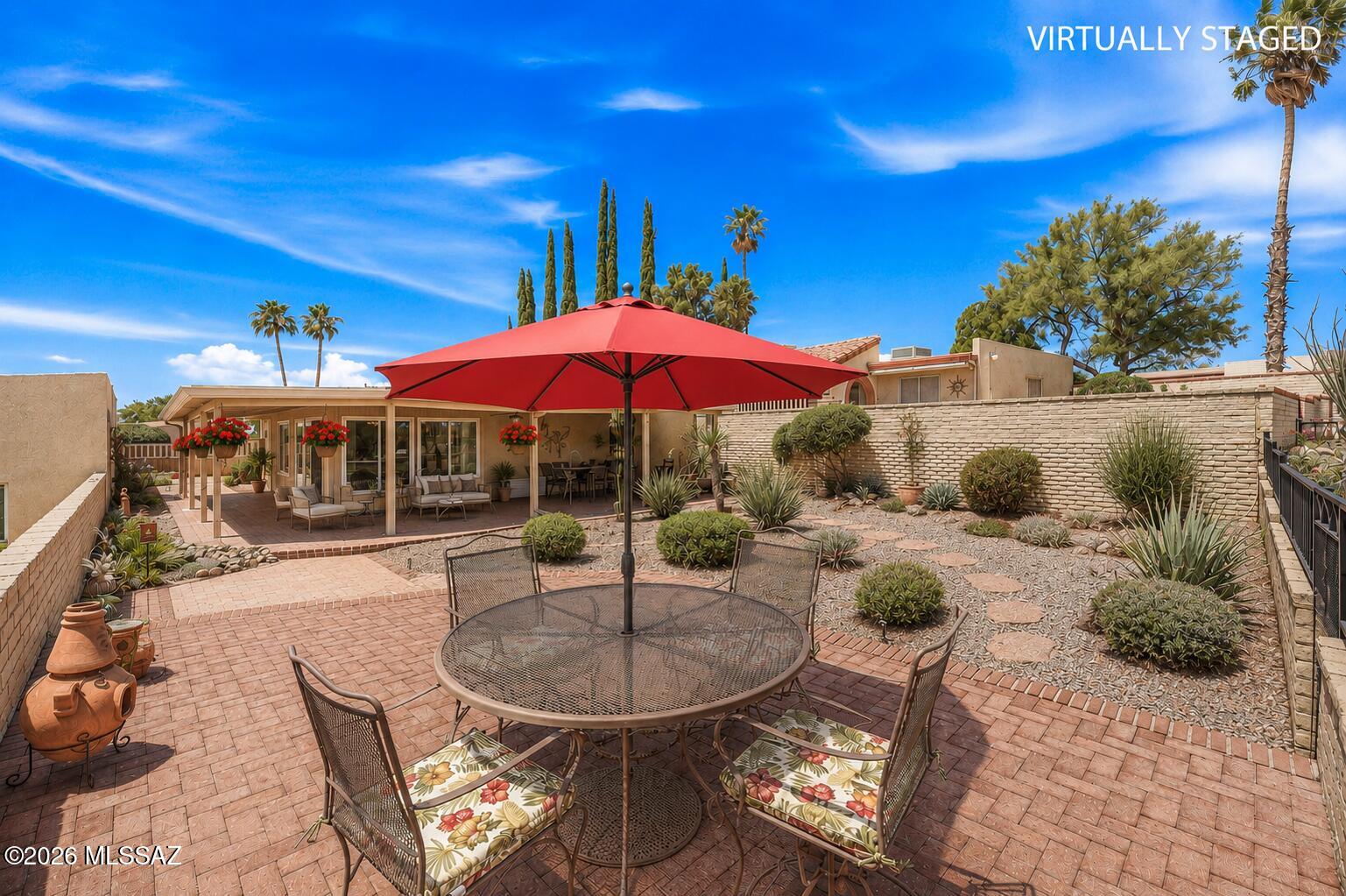 A GOLDEN opportunity awaits you at this pristine home. A beautifully well-maintained stand-alone residence nestled in the heart of Green Valley, Arizona. This immaculate 2-bedroom, 2-bath home is a blend of comfort, style, & smart living. Set on an elevated, spacious lot, this gorgeous home offers breathtaking mountain views from both the front & backyards. Relax or entertain on your wrap-around covered patio, elevated backyard patio, or the inviting gated courtyard entry. The home backs up to a scenic golf course, a tranquil green space as your backdrop. Inside, an updated kitchen with a sunny in-kitchen dining area, perfect for morning coffee. The spacious great room flows into the dining space & a bonus Arizona room, complete with sliding doors to the patio, Ideal for indoor-out living. The main suite features a modern ensuite, while the second bedroom serves well as a guest room or hobby space. Both bathrooms are tastefully updated. Additional highlights include a one-car garage with extra storage, a well-manicured yard, a dedicated laundry room with a high-quality Speed Queen washer and dryer, and energy-efficient updated windows with custom solar screens. A Perfect property for a year-round retreat, a seasonal escape, or a smart investment opportunity, 970 W Camino Sagasta is a must-see. Don't miss out--schedule your private tour today!
