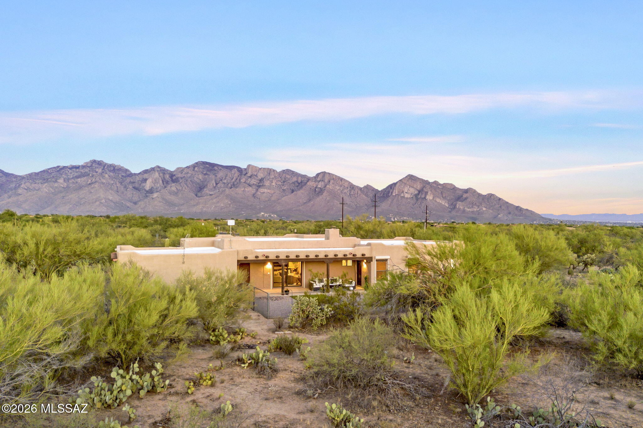 Rare Opportunity Under $1M in La Cholla Airpark -- Stunning Custom Home on 6.91 Acres!

Nestled in the highly desirable La Cholla Airpark community in Oro Valley, Arizona, this single-story 3-bedroom, 2-bathroom custom Santa Fe Home offers approximately 2,326 square feet of comfortable living space on an expansive 6.91-acre lot.

Step inside to a spacious open living area with vaulted ceilings, a built-in wood burning fireplace, adjacent formal dining room, and outside patio access, all ideal for entertaining. The primary bedroom offers a serene retreat with engineered wood flooring and spacious walk-in closet.  The primary bathroom includes a walk-in shower, and separate soaking tub, along with double vanities.  The additional bedrooms and bath provide flexible space for family or guests. The custom kitchen features decorative wood cabinetry, granite countertops, and a sunlit breakfast nook with sweeping mountain views. Additionally, every window/entrance is equipped with rolling shutters for ultimate security and privacy. 

Featuring direct access to the community's 4,500+ foot paved and lighted private runway, this generous lot is zoned for horses and allows for a custom airplane hangar, as well as a guest house or casita. La Cholla Airpark is a coveted private residential enclave where homeowners enjoy planes, horses, and desert wildlife.

Whether you fly in after a trip, stable horses on your acreage, or expand with a hangar and guest house, this property delivers rare versatility and lifestyle potential in one of Oro Valley's most exclusive communities. Don't miss this exceptionally rare opportunity!