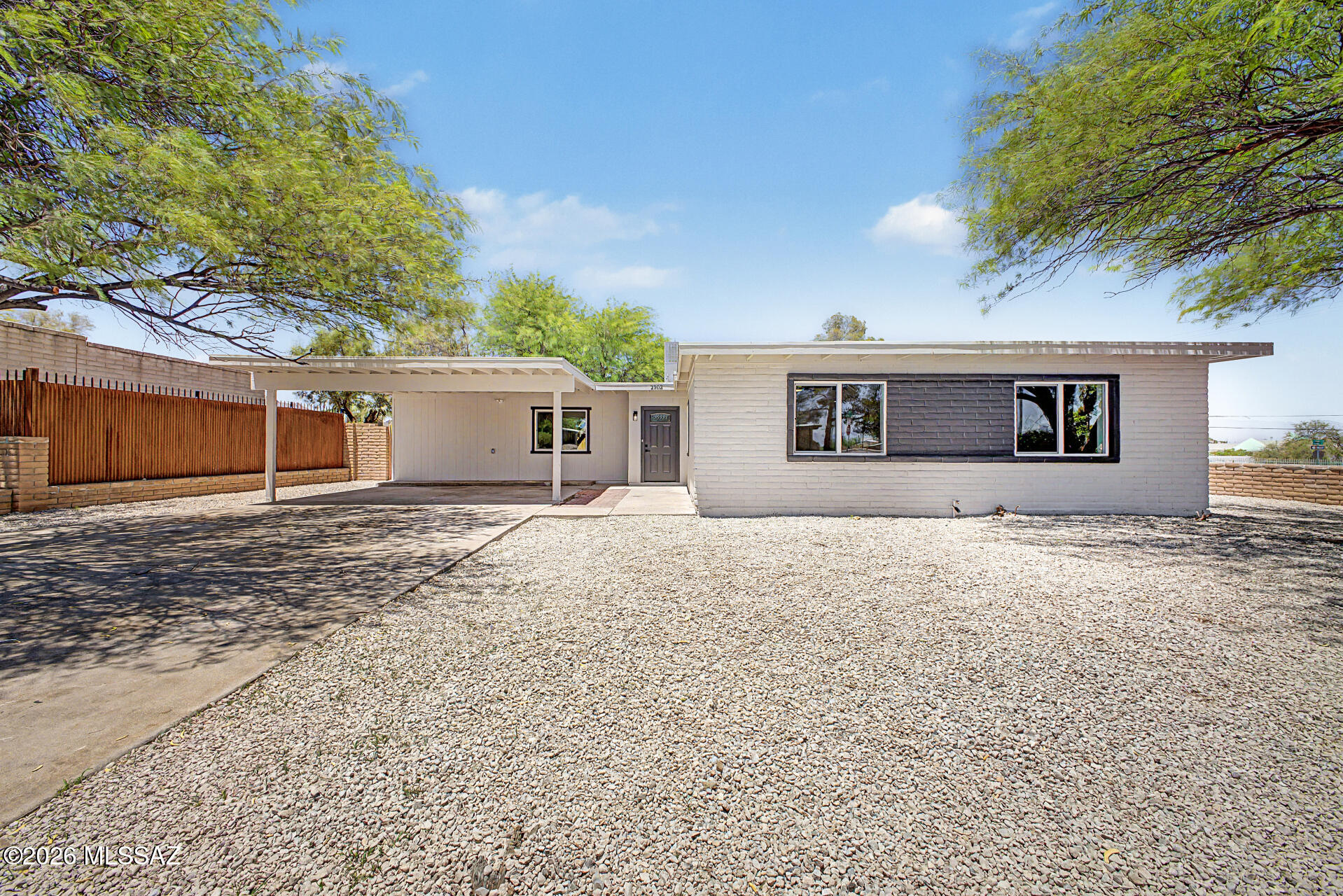 COMPLETELY REMODELED home on a fully fenced corner lot, ready to move in! Freshly painted inside & out, offering 4 beds, 2 baths, 2 carport spaces, & a low-care landscape w/shade trees. The interior boasts clean lines that promote a modern feel! Enhanced by neutral palette, new light fixtures & ceiling fans, and new wood-look flooring t/out. You'll love the welcoming living room and an inviting family room w/fireplace & sliding doors to the back. The renewed kitchen boasts SS appliances, quartz counters, a pantry, and shaker cabinets w/crown molding. Large bedrooms, with the main bedroom having a walk-in closet! Both main & secondary bathrooms have been updated. The spacious backyard provides a covered patio & RV gate to the alley. Enjoy the mountain views! Great location! Owner/ Agent