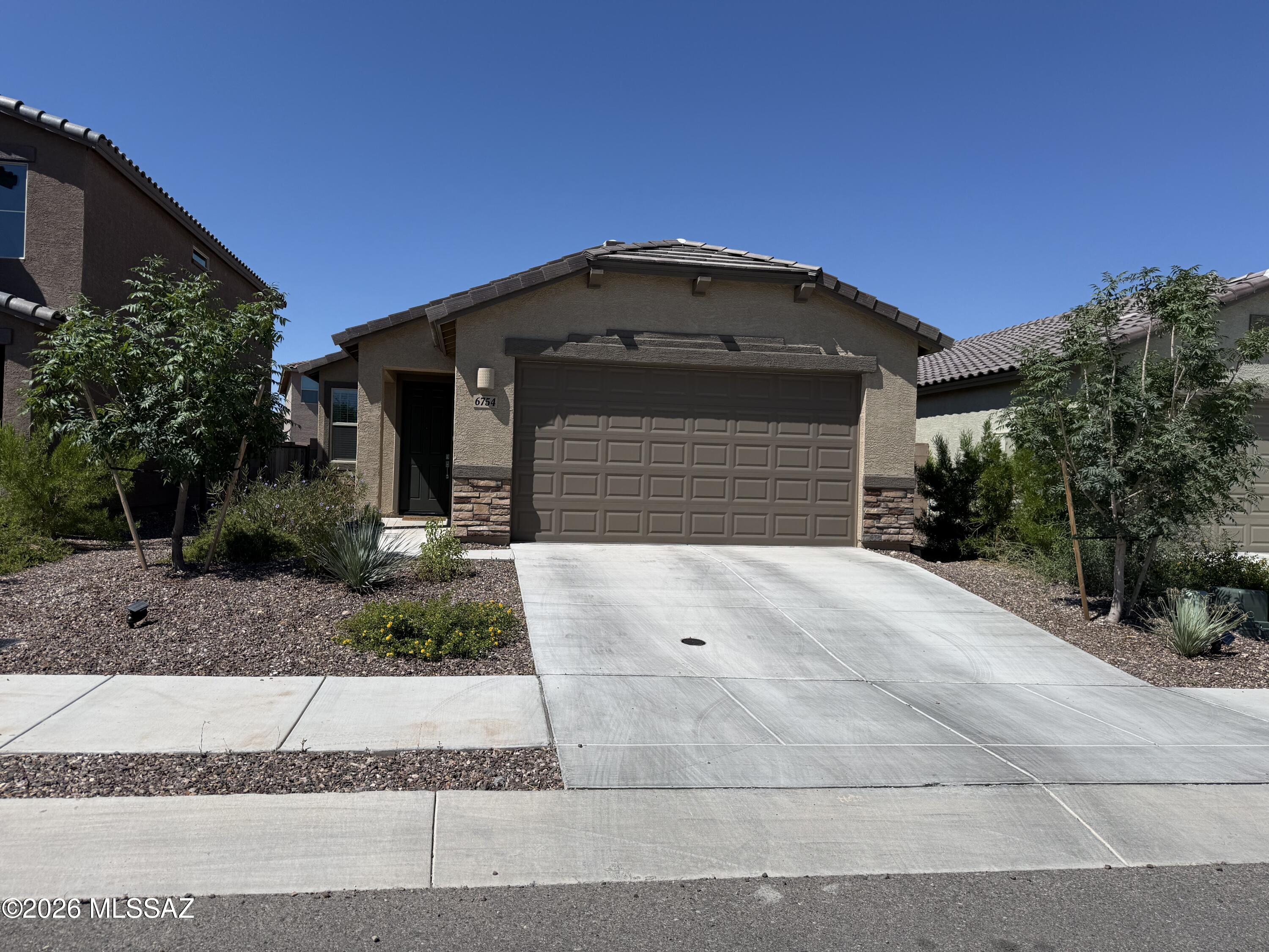 Welcome to this beautifully maintained 2023-built home in the desirable La Estancia community! This move-in ready 3-bedroom, 2-bath home features an open-concept floor plan with a spacious living area, modern kitchen, and private primary suite with a walk-in closet. Enjoy a low-maintenance backyard, covered patio, and attached 2-car garage. Community amenities include a resort-style pool, splash pad, parks, walking trails, basketball and pickleball courts, and a community center. Conveniently located near I-10, shopping, dining, and schools. Don't miss this opportunity to own a like-new home in one of Tucson's growing communities!