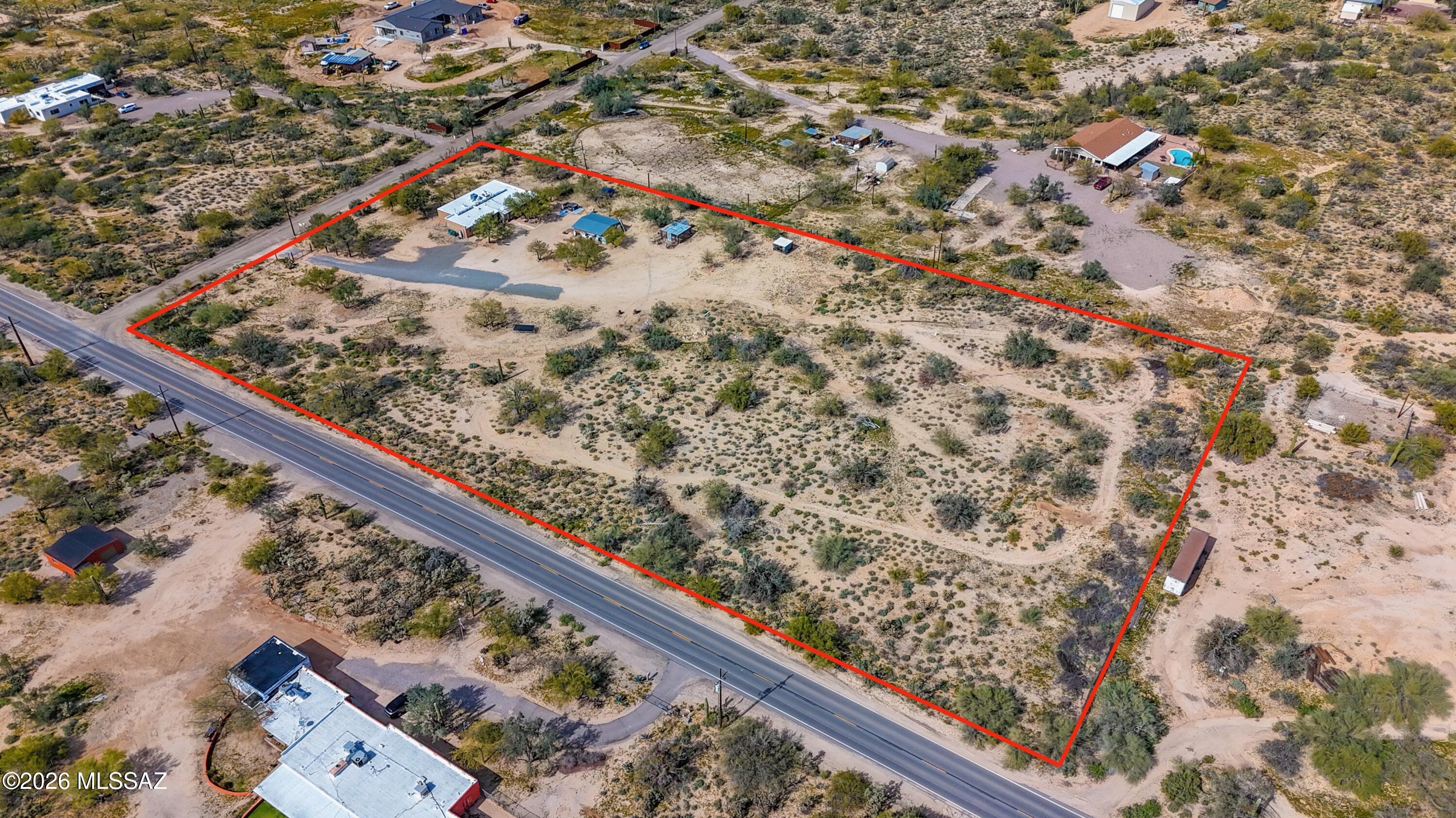Nestled on approximately 4.77 acres of scenic desert landscape in Tucson's sought-after 85742 area, this unique ranch property offers privacy, space, and exceptional potential. The 2,402-sq-ft structure features a flexible layout with spacious rooms and generous closets in every bedroom, ready for renovation or customization. Surrounded by higher-priced homes, this property presents a rare opportunity to invest in a desirable area with strong upside potential. Ideal for investors, hobbyists, or buyers seeking room to expand, the expansive lot provides opportunities for equestrian use, additional outbuildings, or the creation of a private retreat—all while remaining conveniently close to North Tucson amenities.