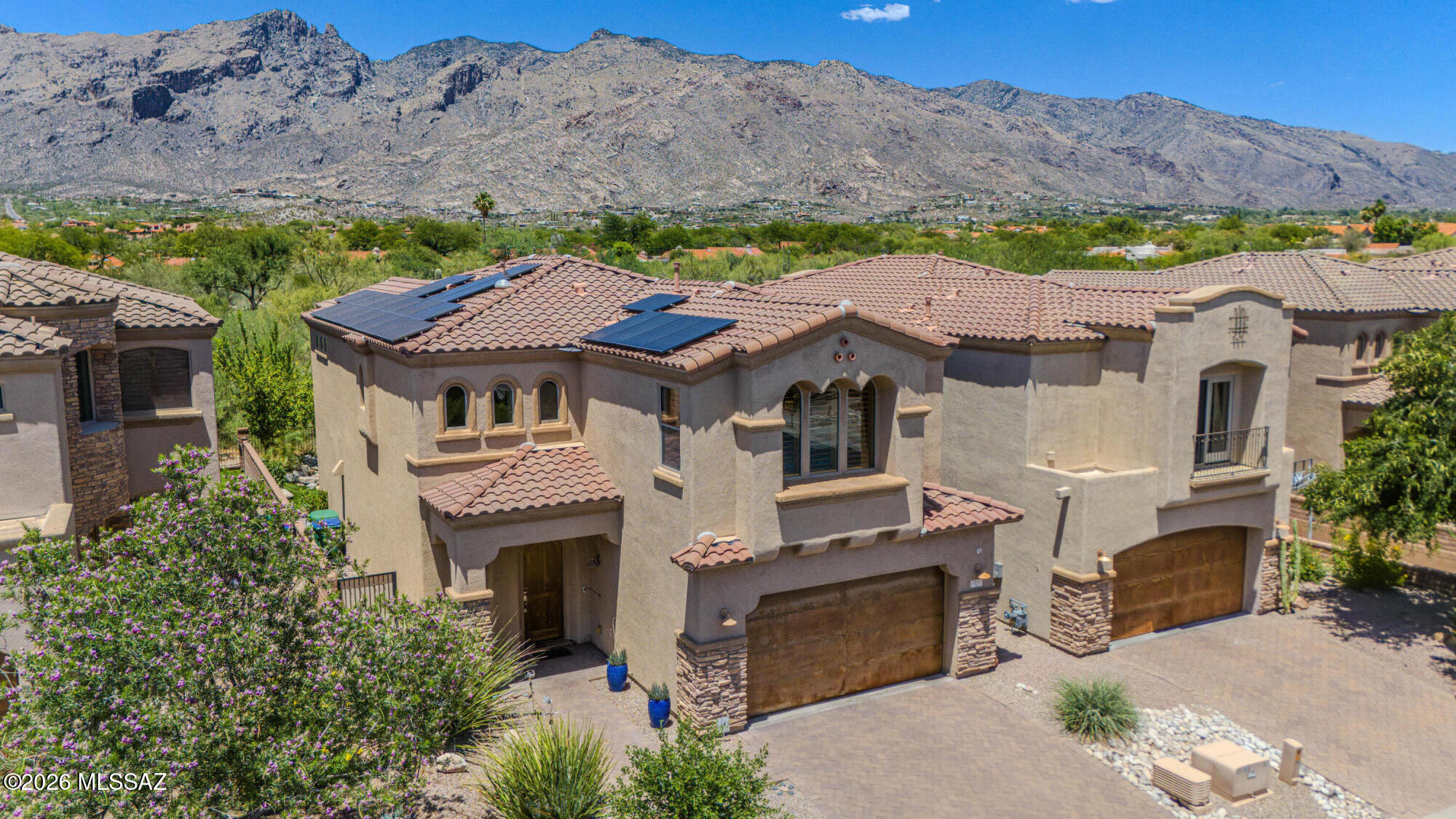 Tucked within the gated community of Paloma Ridge, this exceptional Catalina Foothills residence offers the perfect blend of luxury, privacy, and effortless desert living. Situated on a premium golf course lot with stunning Catalina Mountain views, the home is designed to capture both the beauty of its surroundings and the comfort of everyday living.

Inside, soaring ceilings, abundant natural light, and thoughtfully upgraded finishes create an inviting atmosphere. The open-concept design features granite countertops, cherry cabinetry, a gourmet kitchen with wine chiller, and spacious living areas ideal for both entertaining and quiet evenings at home.

The primary suite serves as a private retreat, complete with balcony access and a spa-inspired bath designed for relaxation. Step outside and discover resort-style outdoor living at its finest. Thoughtfully enhanced with pavers, artificial turf, landscape lighting, a fire pit, water feature, and a fully equipped outdoor kitchen, the backyard was designed for memorable gatherings, peaceful mornings, and spectacular Arizona sunsets.

Additional highlights include a fully owned solar system, extensive builder upgrades throughout, and a location just moments from La Paloma Country Club, premier golf, dining, shopping, and hiking trails.

A rare opportunity to enjoy Foothills living where mountain views, modern efficiency, and timeless elegance come together in one exceptional home.