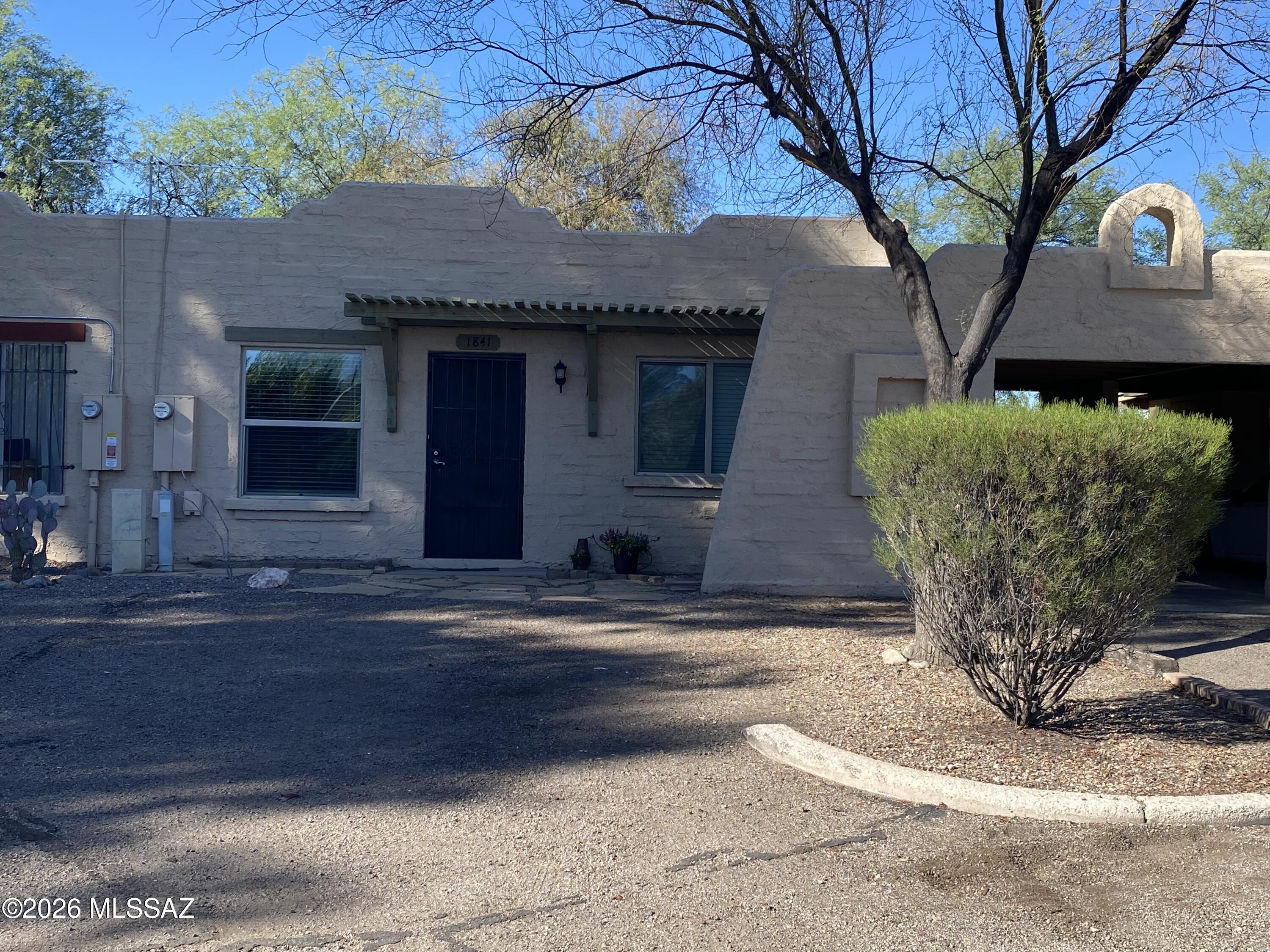 Welcome home to this charming 2BR, 1BA Southwestern pueblo-style townhome, offering comfort, character, and convenience. Step inside to find fresh interior paint, beautiful new laminate flooring, and an updated kitchen that's ready for everyday living. The inviting beehive fireplace adds authentic charm, creating the perfect gathering spot on cool Arizona evenings. Enjoy a private, fenced backyard--ideal for relaxing w/your morning coffee, entertaining friends, or simply unwinding after a long day. Outside, the pueblo-style exterior offers great curb appeal. An attached carport plus 2 parking spaces in front add convenience. The  community features a refreshing pool. Water/trash is included in the rent. Don't miss this wonderful opportunity to enjoy comfortable living. Owner/Agent