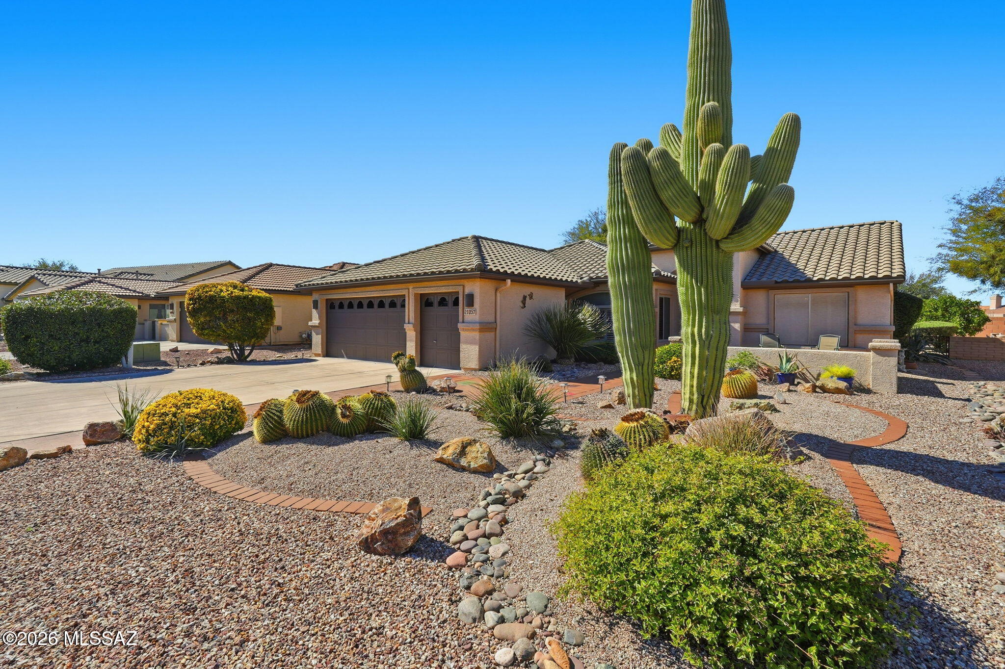 Beautifully maintained Laredo model in the popular active adult Robson community of Quail Creek. This 2 bedroom, 2 bathroom home with a versatile den is being offered fully furnished, making it truly turn-key ready for you to enjoy! Inside you'll find an open and welcoming floor plan, a bright kitchen featuring a center island, stainless steel appliances, quartz countertops and a sunny dining nook. Spacious bedrooms and bathrooms. Large laundry room with cabinets and counter space. The oversized 2½-car garage has room for your golf cart plus additional storage. Enjoy the Arizona sun while sitting in the charming front courtyard or the peaceful screened-in tiled back patio that overlooks the mature backyard landscaping and built-in BBQ. HVAC was replaced in 2024, giving you added peace of  mind. Quail Creek residents enjoy amazing resort-style amenities including an outdoor pool, a new clubhouse with indoor pool, fitness center with mountain views, pickleball and tennis courts, golf, social events and clubs, on-site restaurant and lounge, secure 24-hour guarded gated entrance and so much more! Ideal as your full-time residence or a winter retreat.