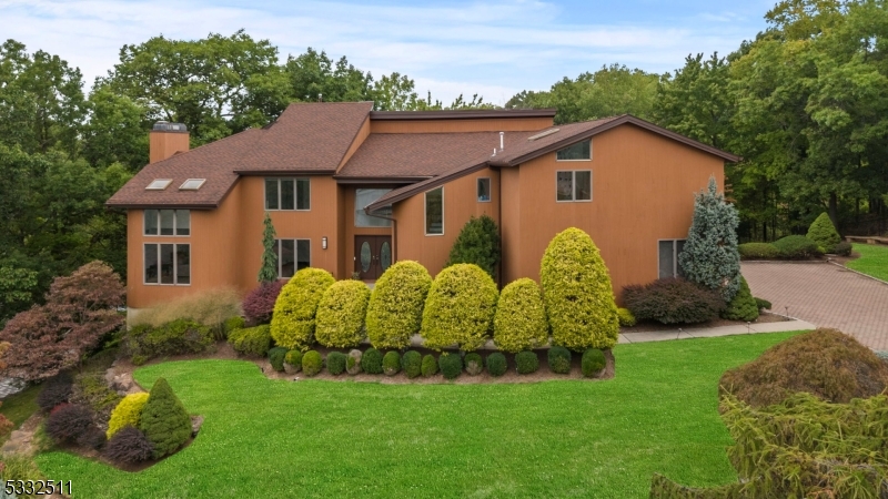 Nestled in a Luxurious neighborhood at the end of a cul-de-sac, this stunning 4,600 sq. ft. contemporary home offers a seamless blend of modern luxury and natural beauty plus an additional 2000+ sq ft fin basement.Bordering Upper Montclair and the scenic Mills Reservation,this home has been meticulously renovated to meet the highest standards of design and comfort. Abundance natural light through expansive windows and skylights, the open-concept layout is perfect for both everyday living and entertaining.The state-of-the-art kitchen is a chef's dream, featuring a 48-inch Wolf stove, 48-inch Sub-Zero refrigerator, quartz countertops,and an impressive 8-foot island. Step outside to the expansive wraparound deck and take in breathtaking views of the Mills Reservation. This home offers 5 bedrooms and 4.5 beautiful bathrooms.The luxurious primary suite is nothing less than breathtaking, Boasting two walk-in closets,a custom makeup vanity, and a spa-inspired bathroom with a soaking tub,a 7-foot custom double vanity, and Porcelanosa finishes.The fully finished walk-out basement is an entertainer's delight, featuring a custom wine cellar, wet bar, fireplace, and plenty of space to gather.Additional highlights include 5-zone central air,a 6-year-old roof,and proximity to NYC transportation and the vibrant Montclair lifestyle.This contemporary masterpiece offers unparalleled elegance, privacy, and convenience an exceptional opportunity in one of the area's most sought-after locations!
