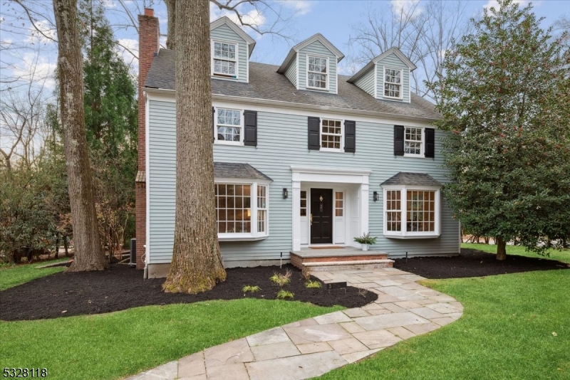 Classic Elegance Meets Modern Living! This timeless Colonial home offers a seamless blend of classic charm & modern updates in one of Summit's most desirable locations. Close to top-rated schools, NJ Transit, major highways, shopping, dining & the serene Watchung Reservation. The beautifully landscaped corner property creates stunning curb appeal, leading to a stately front entry that opens to a bright & airy main level. Gleaming hardwood floors, recess lighting, elegant crown molding & chair rail detailing enhance the classic ambiance. The living room features a cozy wood-burning fireplace, while the formal dining room provides the perfect setting for gatherings. At the heart of the home is an updated eat-in kitchen w/crisp white cabinetry, SS appliances & center island. The adjoining breakfast nook boasts vaulted ceilings, skylights, direct access to both the backyard & attached garage. An updated powder room & a versatile office/den w/built-ins add to the main level's appeal. The backyard offers a low-maintenance retreat with a generous stone patio. Upstairs a generous primary suite w/a spa-like bath featuring a corner jetted tub, glass shower & dual vanity.  2 additional bedrooms & a full hall bath complete this level. The third floor includes 2 more spacious bedrooms & another full bath. The finished basement expands the living space w/a rec-room, laundry area & abundant storage. Move-in ready w/a freshly painted main level, this home is ready to welcome its new owners.