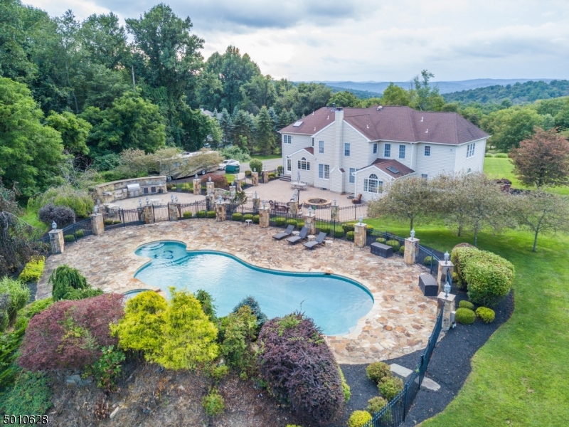 Vacation at home!  Incredible 40k gallon Gunite heated pool with hot tub area and waterfall are surrounded by paver stone patio with 27 lighted stone pillars. Over 4000sf of patio area features a gas fire pit and outdoor kitchen.  A total of 5 usable acres located on a quiet cul de sac of Middlesworth Farm, a community of fine homes.  The 2 story grand foyer leads to a fabulous floorplan for both work and fun - large, private home office, conservatory, formal living and dining rooms, sun room, spacious family room with gas fireplace, gourmet granite kitchen with center island and large breakfast area.  The second floor features hardwood flooring throughout, double door entry leading to the luxurious master suite sitting room with gas fireplace, large walk-in closet and full bath and 3 additional en suite BRs.