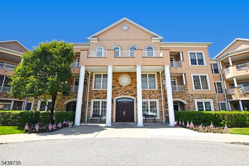 First-floor Fox Hills condo featuring 1 bedroom, a den and 1.5 baths. Opportunities to purchase a 1.5-bath unit in Fox Hills are uncommon, making this a highly desirable offering. Located in the sought-after Jefferson Building, this well-maintained home enjoys an unobstructed front-facing view and features hardwood flooring throughout, newer windows in the den (2022), stainless steel appliances, and a high-efficiency stackable washer and dryer, all included.  Enjoy the convenience of being located close to the clubhouse and community amenities. Garage parking and storage in the lower level of the building.  Fox Hills is a vibrant active adult community offering a 24-hour gated guardhouse, clubhouse, indoor and outdoor swimming pools, billiards room, resident jitney service, and a wide variety of social activities and clubs.  Conveniently located near shopping, dining, and major highways, this home offers the perfect combination of comfort, convenience, and an active lifestyle.