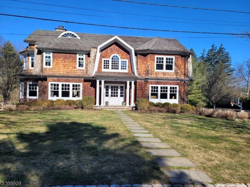 This custom home, built on the original and expanded foundation will WOW you from the moment you arrive.  Located on The Pond in Old Short Hills this house was lovingly designed & curated by its current owners. No detail was overlooked.  From the custom windows, wide planked wood floors, high end fixtures & finishes everything was hand picked to create a spectacular environment. Featuring a spectacular Chef's Kit w/High End SS Appl, Oversized Island w/Danby Marble Countertop, Italian Tile Backsplash, custom cabinetry, gorgeous hardware & a sunny breakfast area.  Access from the kit. to the raised deck w/pergola makes al fresco entertaining a breeze! The custom bathrms are outfitted w/Water Works fixtures.  The1st fl also boasts a lg home office w/custom built-ins, A grand DR perfect for hosting, a beautiful formal LR & a Great Rm open to the kit w/views of the pond.  Upstairs the primary suite is the ultimate refuge after a hectic day & a birds eye view of the pond greets you every morning.  Complete with a gas fp, his/hers closets & gorgeous ensuite bath w/jetted tub, shower & dual vanities. 3 more spacious bedrooms & 2 bathrms (1 ensuite) & laundry rm round out the 2nd fl. The third level features a bedrm, full bath, sitting room & tons of storage. The finished LL features a diner themed eating/game area, home gym & cozy media/rec rm.The lg side yard provides plenty of room to play. The firepit area is the perfect spot to gather on a beautiful evening.