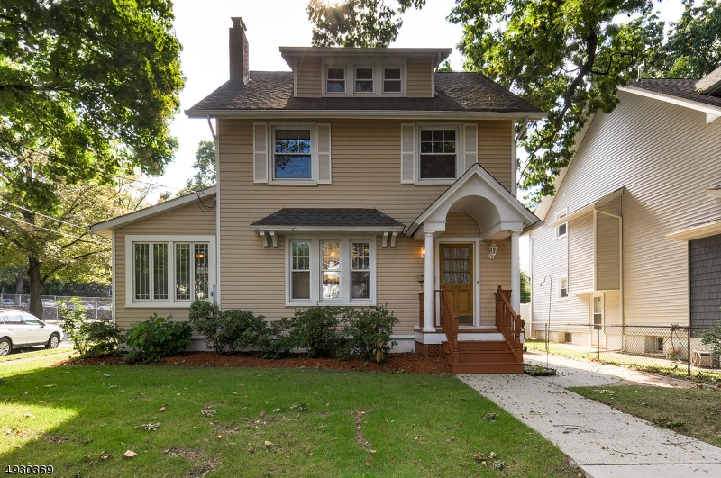 BEAUTIFUL TREE-LINED STREETS WILL LEAD YOU TO THIS LARGE COLONIAL ON A CORNER LOT!!! Bright, welcoming living rm w/ fireplace, sunporch with heat and ceiling fan to enjoy year-round. Walnut bordered hardwood, crown molding & bay window in the formal dining room. Corian countertops & pantry w/ shelving in kitchen. Enter through one of the large 2nd floor bedrooms and enjoy extra living space in the 16x6 porch. Third level offers even more living space with a 12x10 bedroom, sitting area & alcove, along with a pedestal sink. 2 car garage and plenty of room in the backyard ... complete with underground sprinkler!