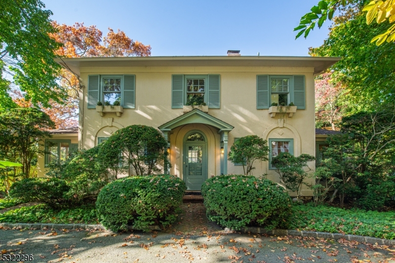 Welcome to this enchanting Belhall Colonial, a timeless treasure built in 1922, on a level .45 acre lot on the shores of Mountain Lake. This home has stunning sunset views & a harmonious blend of classic charm & modern amenities. Beyond the welcoming foyer, you'll be greeted by a formal DR that seamlessly flows into an expansive LR, featuring a wood-burning fireplace. Adjacent to the LR is a delightful guest rm and a full bath w/a shower and pedestal sink. A powder rm is set just off the entrance foyer. Pass through a charming archway to the FR addition, where walls of windows frame glorious lake views. Sliders on either side of the room lead to side fiberglass decks, perfect for enjoying the views. The bright kitchen boasts Corian countertops & SS appliances, complemented by an inviting breakfast rm w/a vaulted ceiling & sliders leading to the deck. The backyard is a captivating retreat w/sweeping lake views & a gazebo by the water's edge. On the 2nd fl, the luxurious primary suite offers stunning lake views thru its expansive windows, along w/built-in shelving, a WIC , & a primary bath w/a dual vanity & tub/shower. 3 more bedrooms share a hall bath w/a shower & pedestal sink, while a laundry rm off the 2nd fl hall presents the potential for an ensuite bath in the future. The LL has a rec rm, a half bath, cedar storage & utilities. Additional features include a 2-car built-in garage, newer AC, roof & newer windows. Enjoy the wonders of this lakefront lifestyle!