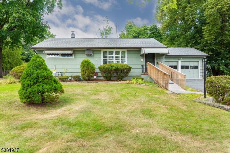 Welcome to this inviting ranch-style home that combines warmth, space, and opportunity. Set on a generous, tree-lined lot, this home offers wonderful curb appeal with mature landscaping, a charming front entry, and an accessible ramp leading to the covered porch. Step inside to find a sun-filled living and dining area highlighted by a large picture window, fresh carpeting, and plenty of natural light. The cozy kitchen, accented with wood cabinetry and a breakfast bar, flows easily into the main living spaces, making it perfect for everyday living and entertaining. A Family Room with fireplace and tiled flooring adds extra space for relaxation, hobbies, or gatherings year-round. The bedrooms are comfortable in size, while the lower level features a spacious basement ready to be transformed into a rec room, gym, or home office. Outside, the flat, fully usable yard is ideal for gardening, play, or summer barbecues, with a screened porch and deck offering the best of indoor/outdoor living. Completing the package is an attached garage and long driveway for easy parking. This well-loved home offers incredible potential move right in or bring your design ideas to create the space you've always dreamed of. Conveniently located near schools, parks, shopping, and commuter routes, this is a rare opportunity to own a home with space, character, and value in today's market.
