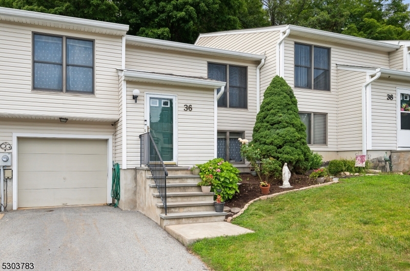 Spacious Townhome in a Serene Setting! Updated 1,800+ sq ft unit in Walden Village with 3 bedrooms, 3 full baths, 1-car garage, and tons of amenities. Excellent location near downtown Hamburg, with shops, restaurants, golf and more all in close proximity. A welcoming foyer welcomes you inside this gorgeous sun-filled unit with gleaming wood floors and an airy layout. The main level features a stunning open living and dining room with chair rail detail, and direct flow into a beautiful kitchen renovated in 2018 with creamy white cabinets, granite counters, striking tile backsplash and stainless steel appliances. Sliding doors off the breakfast nook leads to a cozy balcony that's perfect for sipping coffee or cocktails in the sun. Your tranquil main-floor primary oasis awaits with a generous bedroom, 2 closets and an en-suite bath, with another sizeable bedroom and second full bath right down the hall. The finished lower level offers a sprawling family room with a wood burning fireplace and sliding doors to a covered patio for easy indoor/outdoor entertaining. This floor also hosts the third bedroom, third full bath, garage access, and a utility room with laundry and storage space. Peaceful community with many resident amenities like a club house, in-ground pool and adjacent playground, tennis courts and more.