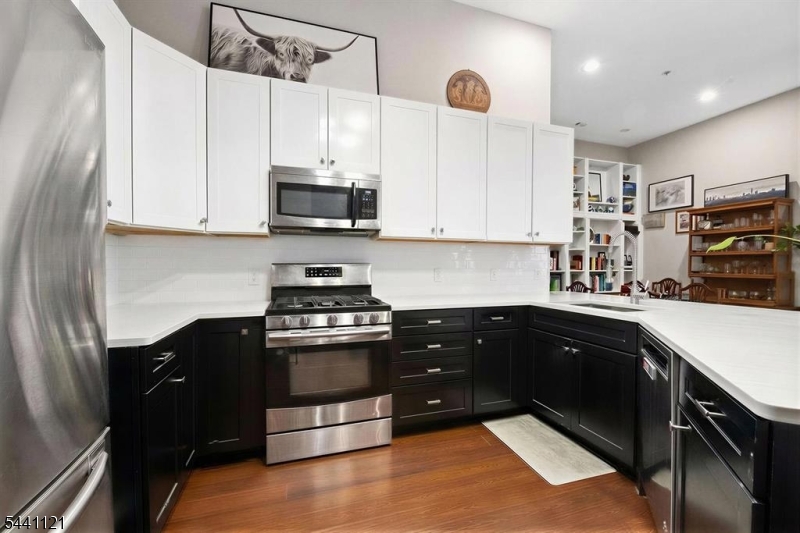 Welcome home to this beautiful 2 bedroom 2 bath condo in Paulus Hook.  This spacious 1320 sq ft home features souring 12 ft ceilings, south facing windows and 2 terraces overlooking the courtyard.  This beautiful renovated home has expresso hardwood floors throughout and an impeccably maintained modern kitchen with Caesarstone counters, Samsung stainless steel appliances, and subway tile backsplash.  Additional features of the home include in unit washer/dryer and deeded garage parking spot included.  Pier house is a full service 24 hour building, featuring a common landscaped courtyard, outdoor pool, reception lounge and fitness center.  The neighborhood features many public and private school options.  Located at Liberty Landing Marina and near river walk., parks, PATH stations, light rail and ferry services. One deeded parking  spot included.