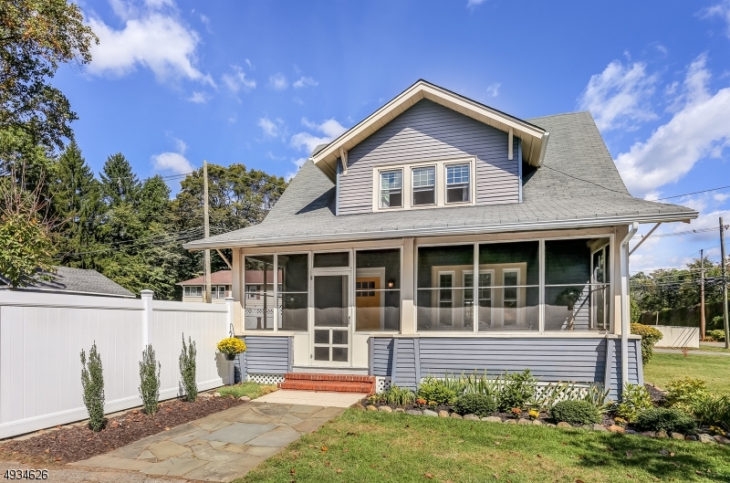 Charm & Curb Appeal describe this classic colonial.  Wood floors, built ins, beautiful natural wood touches.  Enter the enclosed lemonade porch to the living room with stained glass window. Greeted by a built in bench w/storage & original wood banister stairs going up to bedrooms.  Hdwd floors & new windows in the living & dining rm w/large picture windows let in natural light.  Custom built ins add storage & more charm to this lovingly maintained home.  The kitchen's decor compliment the vintage touches.  Adjacent to the kitchen & dining room is a bonus rm to be used as office or a place to unload after working in the yard. Upstairs has 2 bedrms & 1 full bath.  The mster bedrm has 4 closets. Garden lovers enjoy a large open lot also for great parties.  Detached & updated 2 car large garage. 200 amp electric.